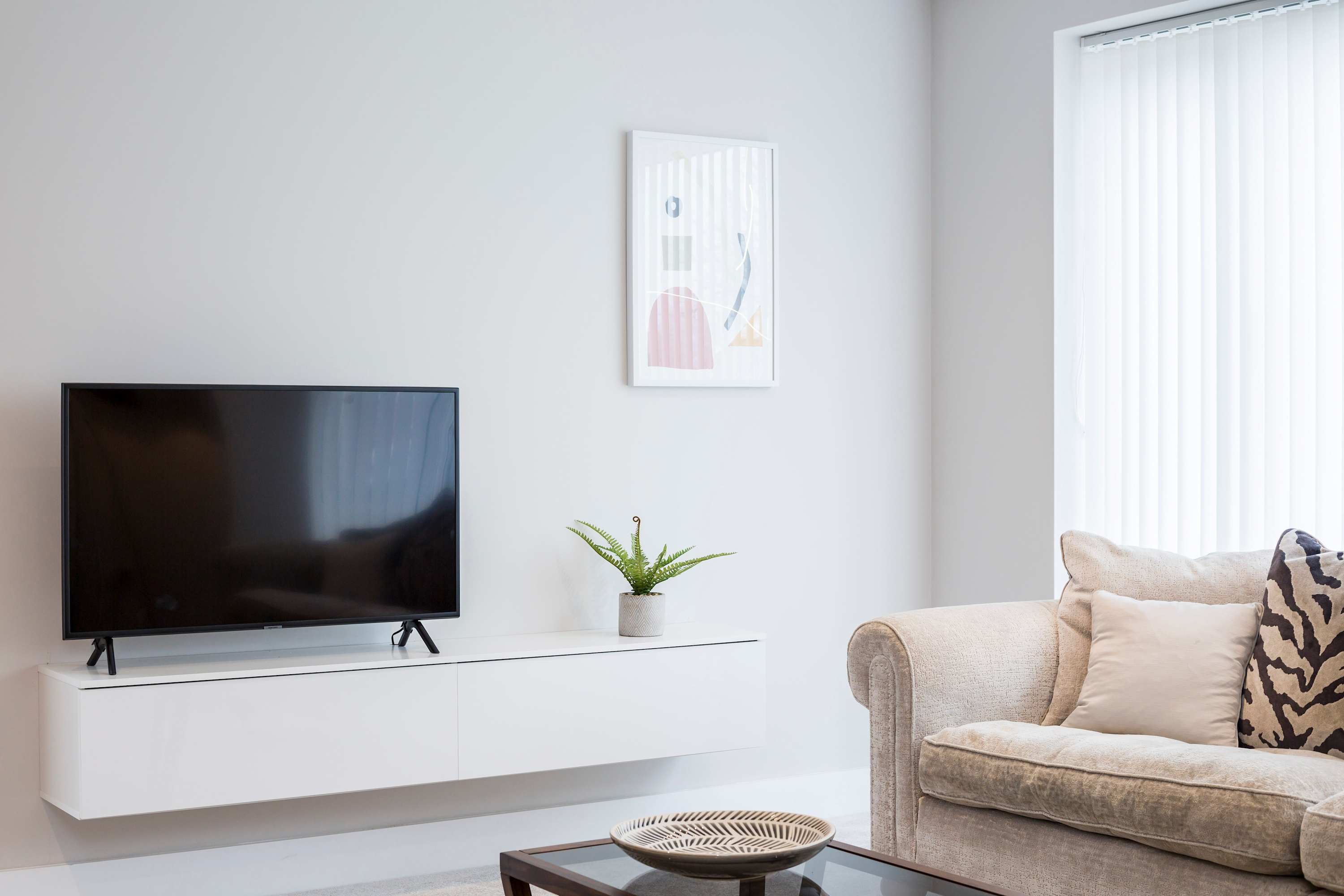 The smaller of the two lounges, featuring a sofa and flat screen TV.