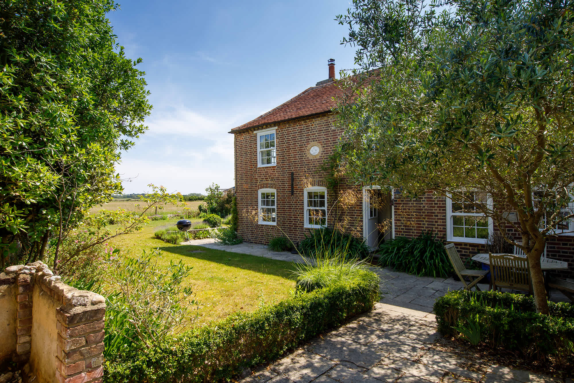 The beautiful cottage, with the sea in the distance