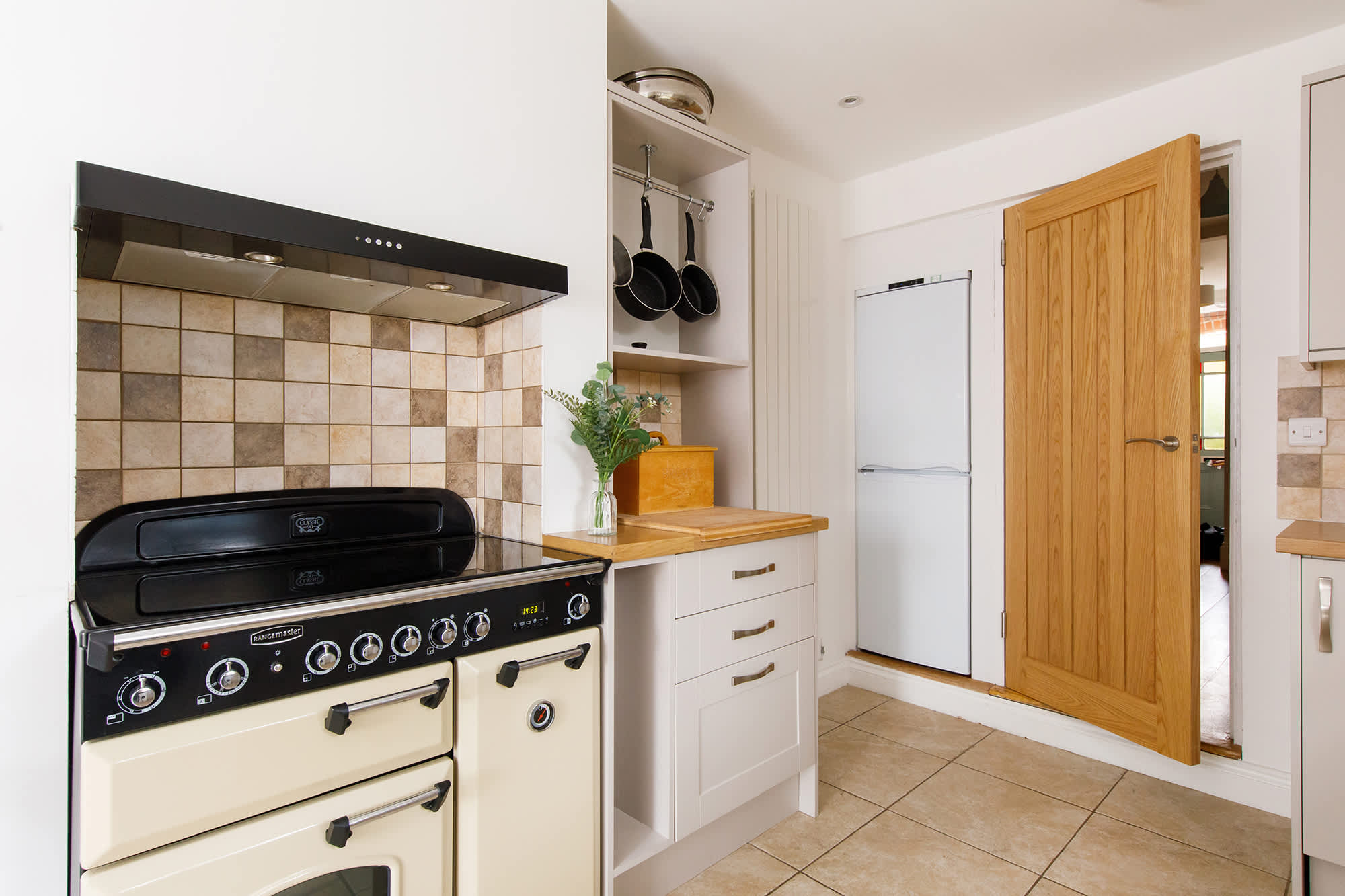 An adjacent kitchen has everything you need for your stay.