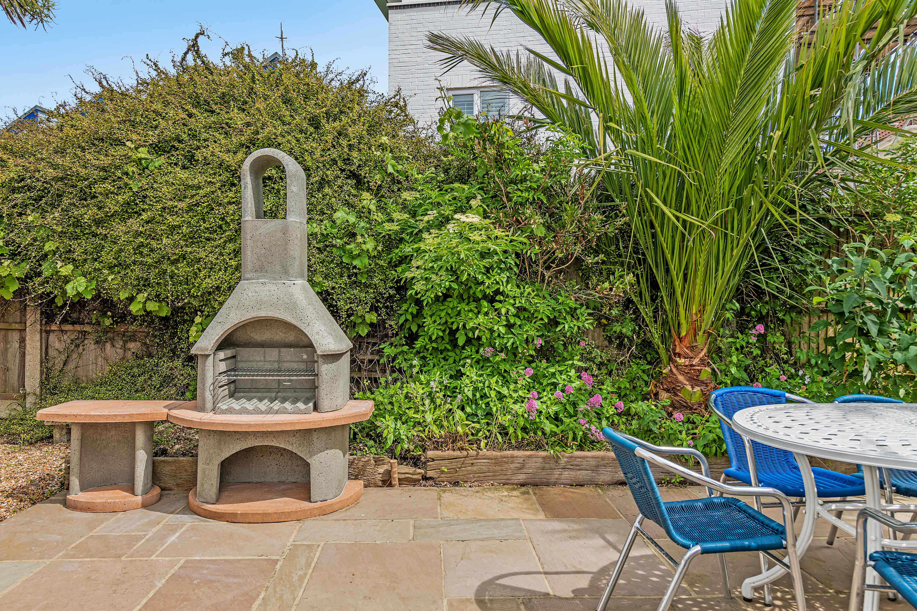 Indispensable outdoor amenities include an inviting seating area with stone BBQ