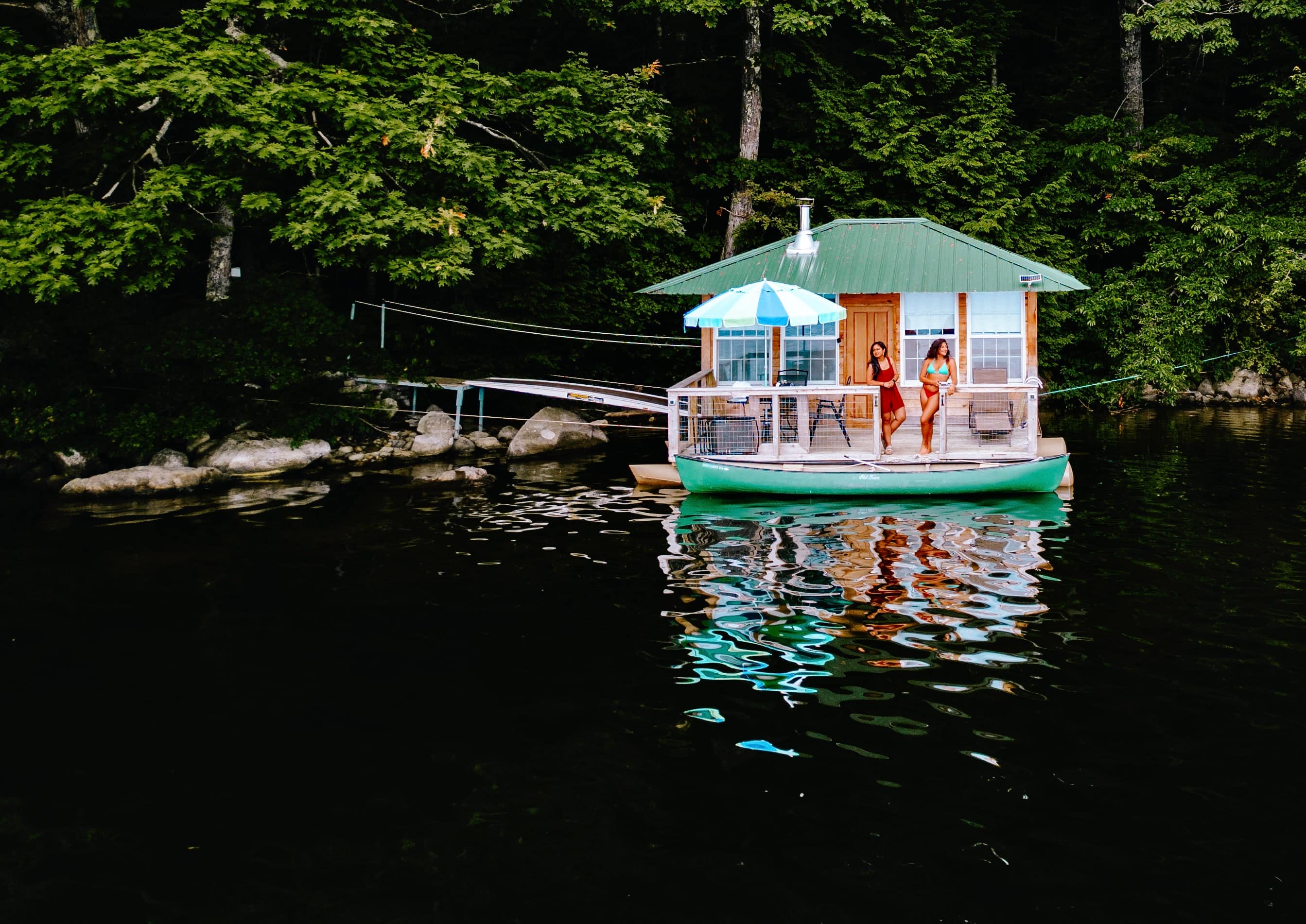 Sleep in this floating cabin / houseboat. relax on the front porch, cook over the fire or grill on the lake shore.