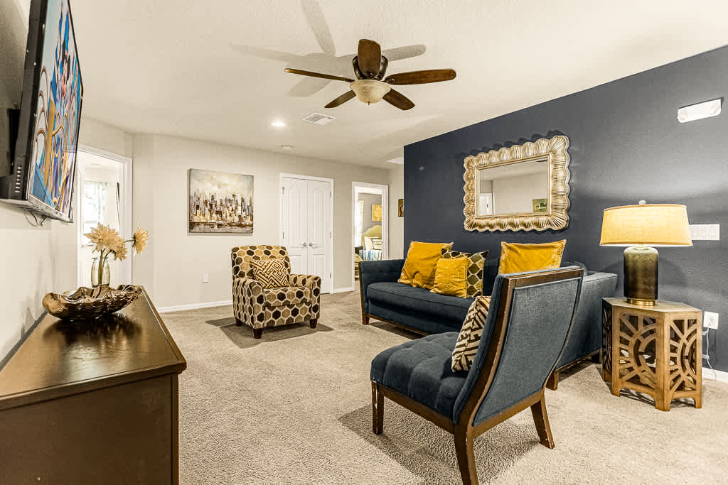 Relax in style with this chic living room featuring a cozy sofa, vibrant decor, and a modern touch perfect for unwinding.