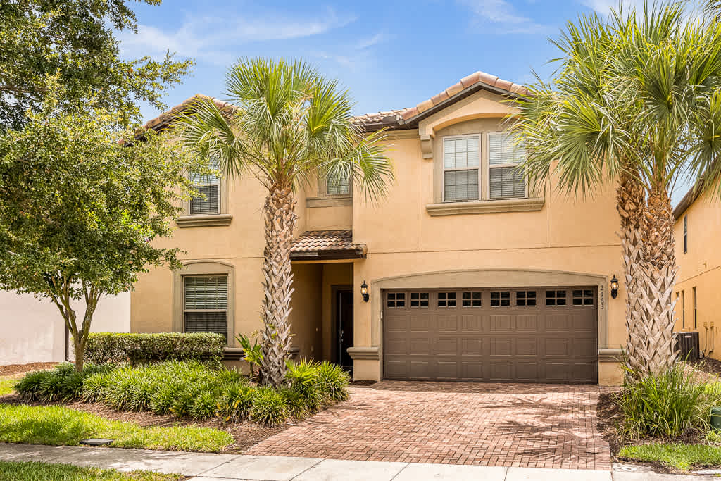 Welcome to your tropical retreat! This elegant home boasts lush landscaping and a spacious garage, perfect for your next getaway.