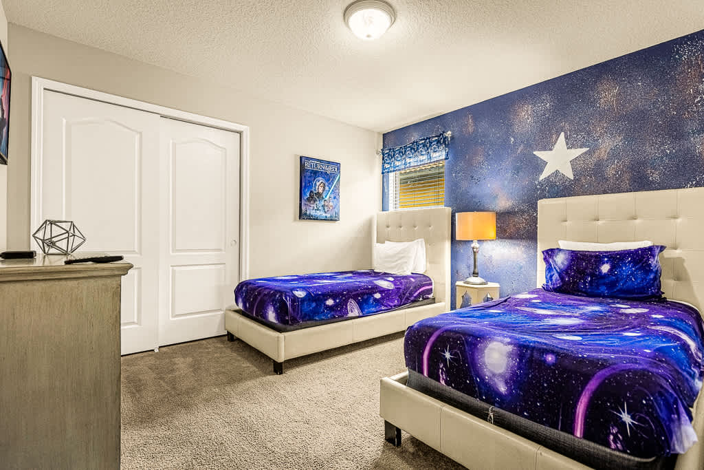 Blast off into dreamland in this cosmic-themed room, perfect for stargazers and space enthusiasts!