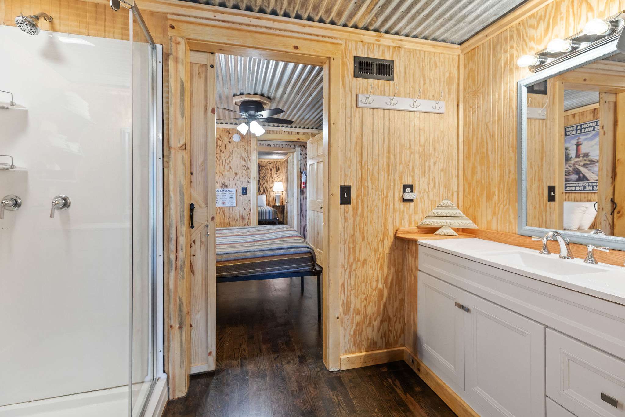 Bathroom with step in shower, shared between bedrooms.