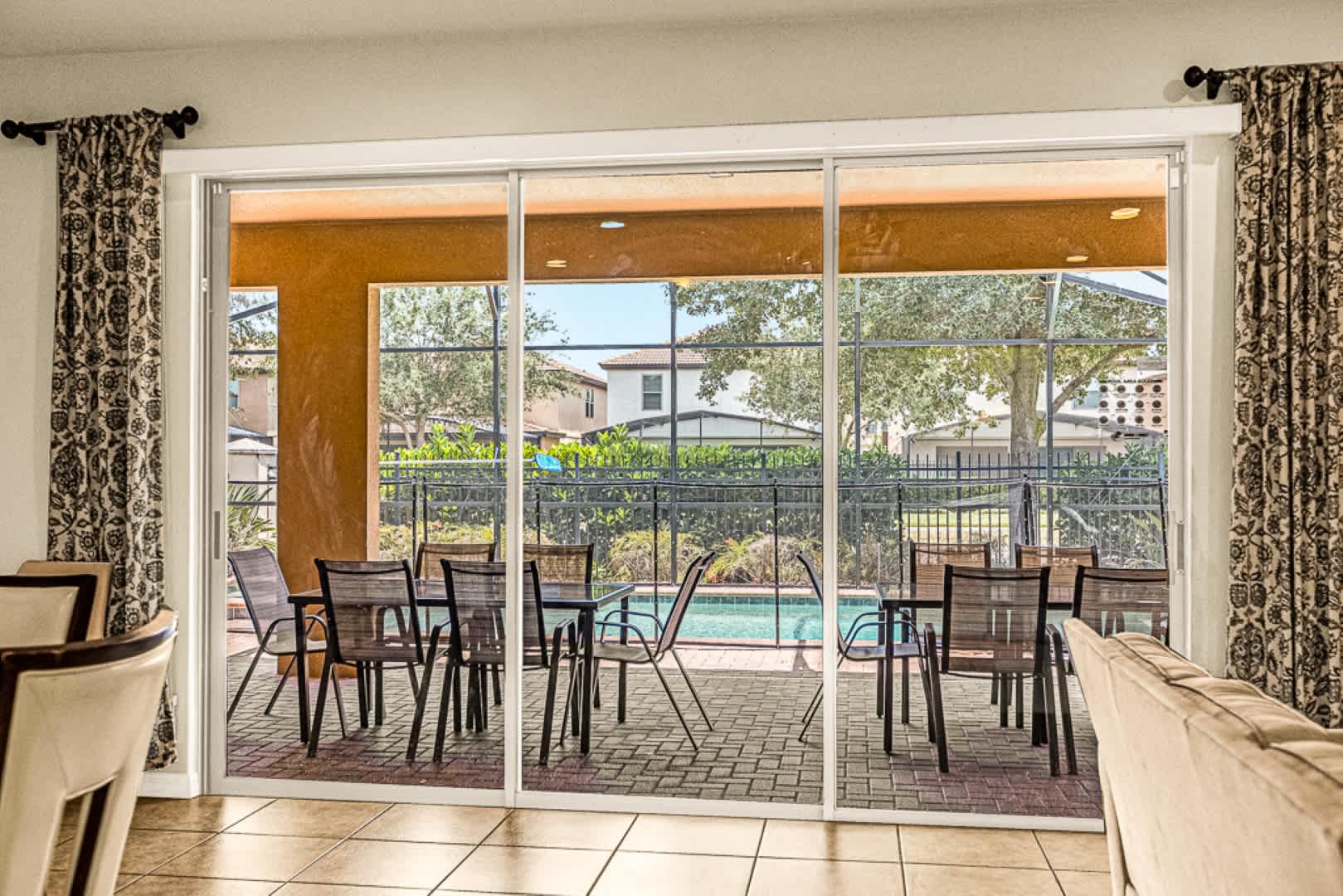 Relax on the spacious patio with pool views, perfect for gatherings in a tranquil setting.