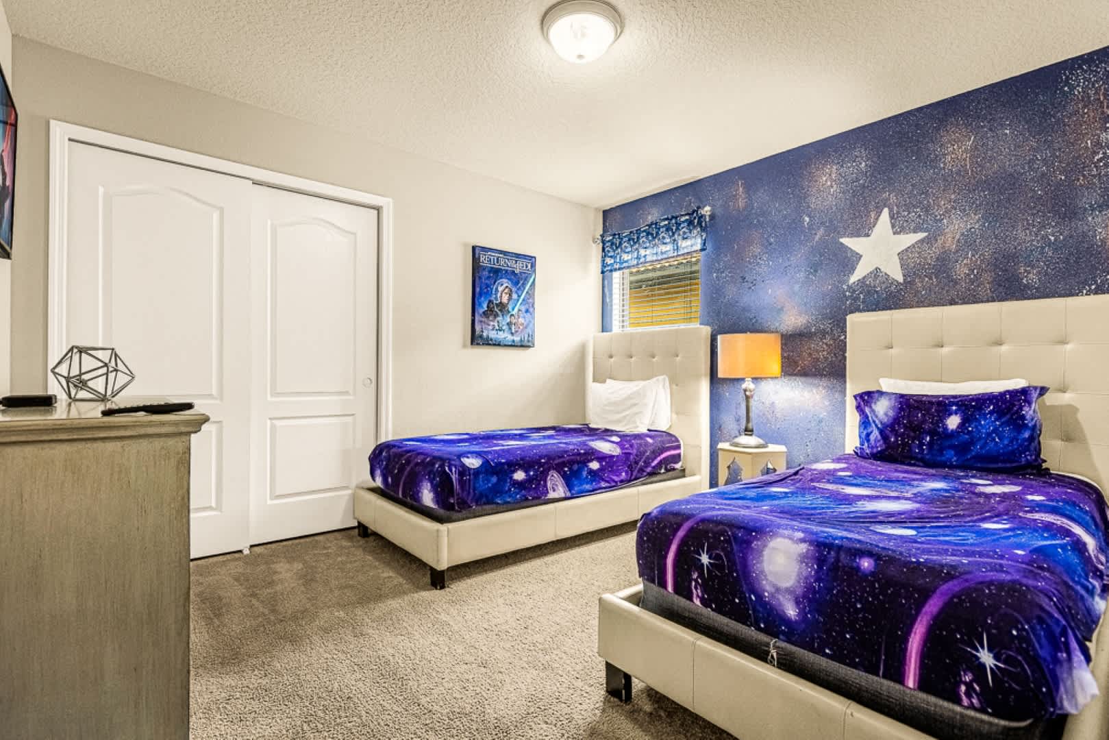 Explore the universe in this galaxy-themed bedroom, complete with twin beds and cosmic decor, perfect for dreamers of all ages.
