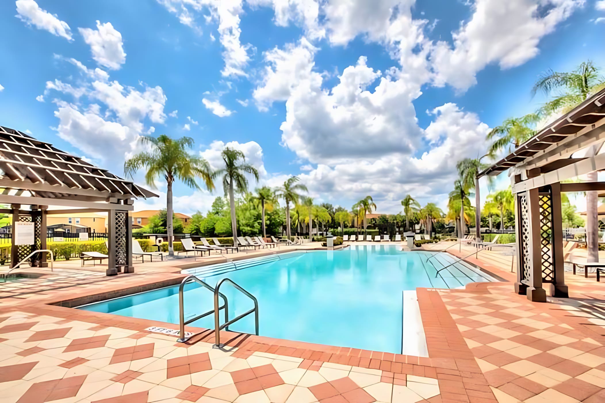 Gorgeous Resort Pool Surrounded By Palm Trees And Relaxing Loungers