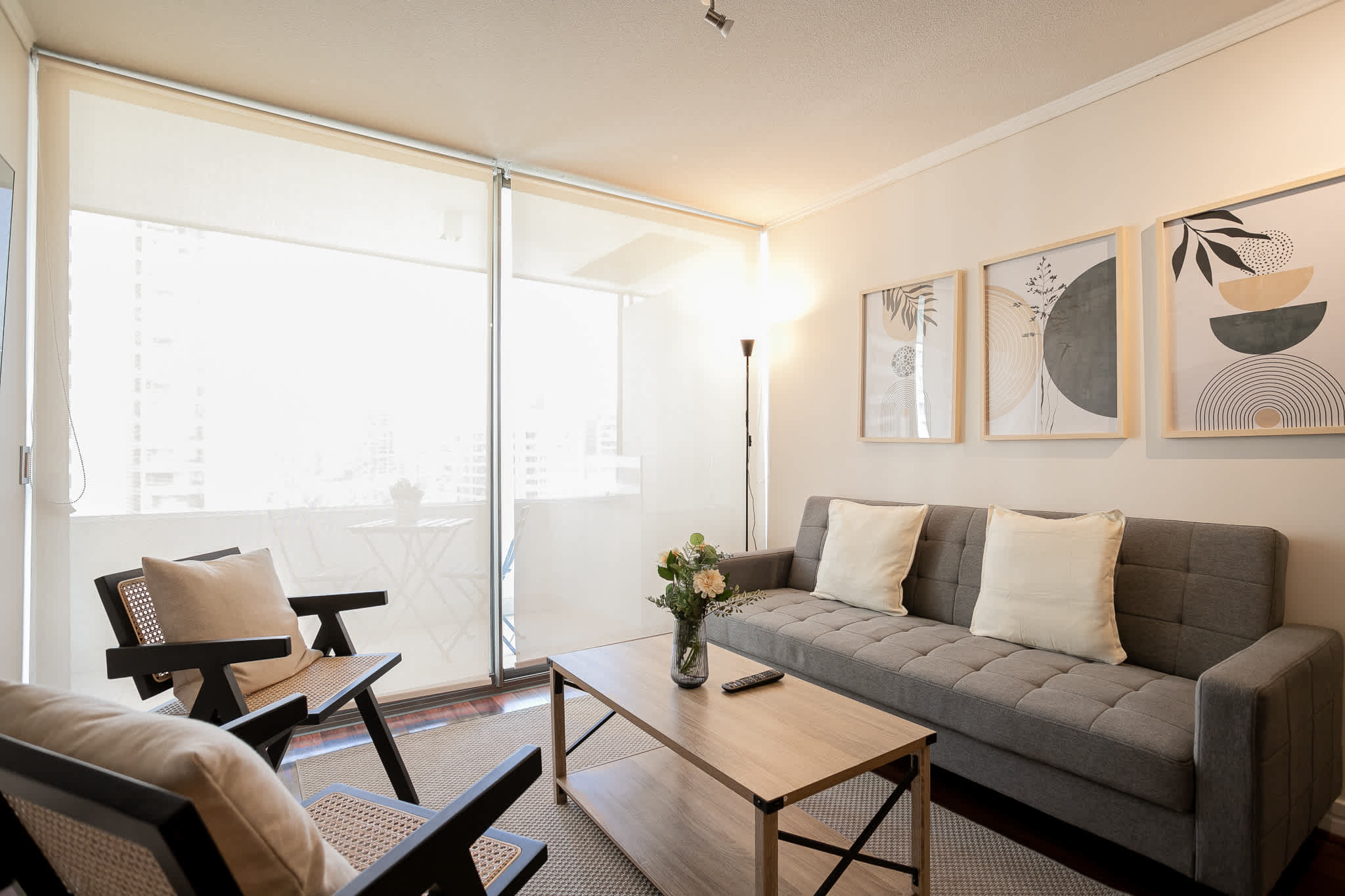 Relax in this stylish living room, bathed in natural light with chic decor and a cozy atmosphere, perfect for unwinding after a day exploring the city.