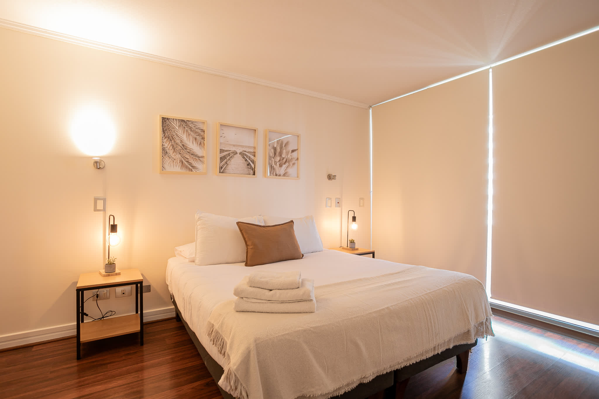 Relax in this serene bedroom with cozy bedding and stylish decor, perfect for unwinding after a day of exploring.