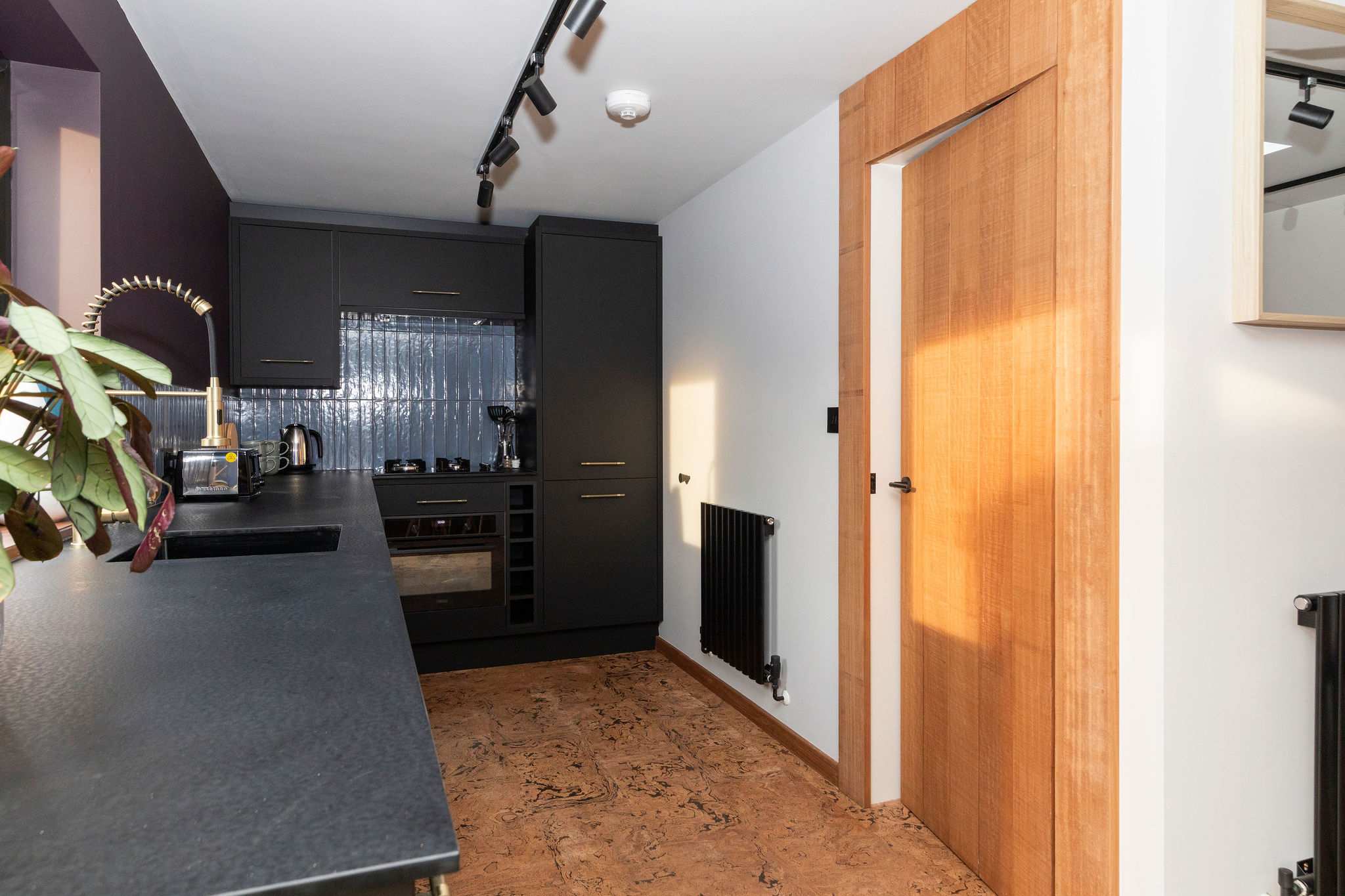 The black countertops and cabinetry give the kitchen a sleek, modern feel.
