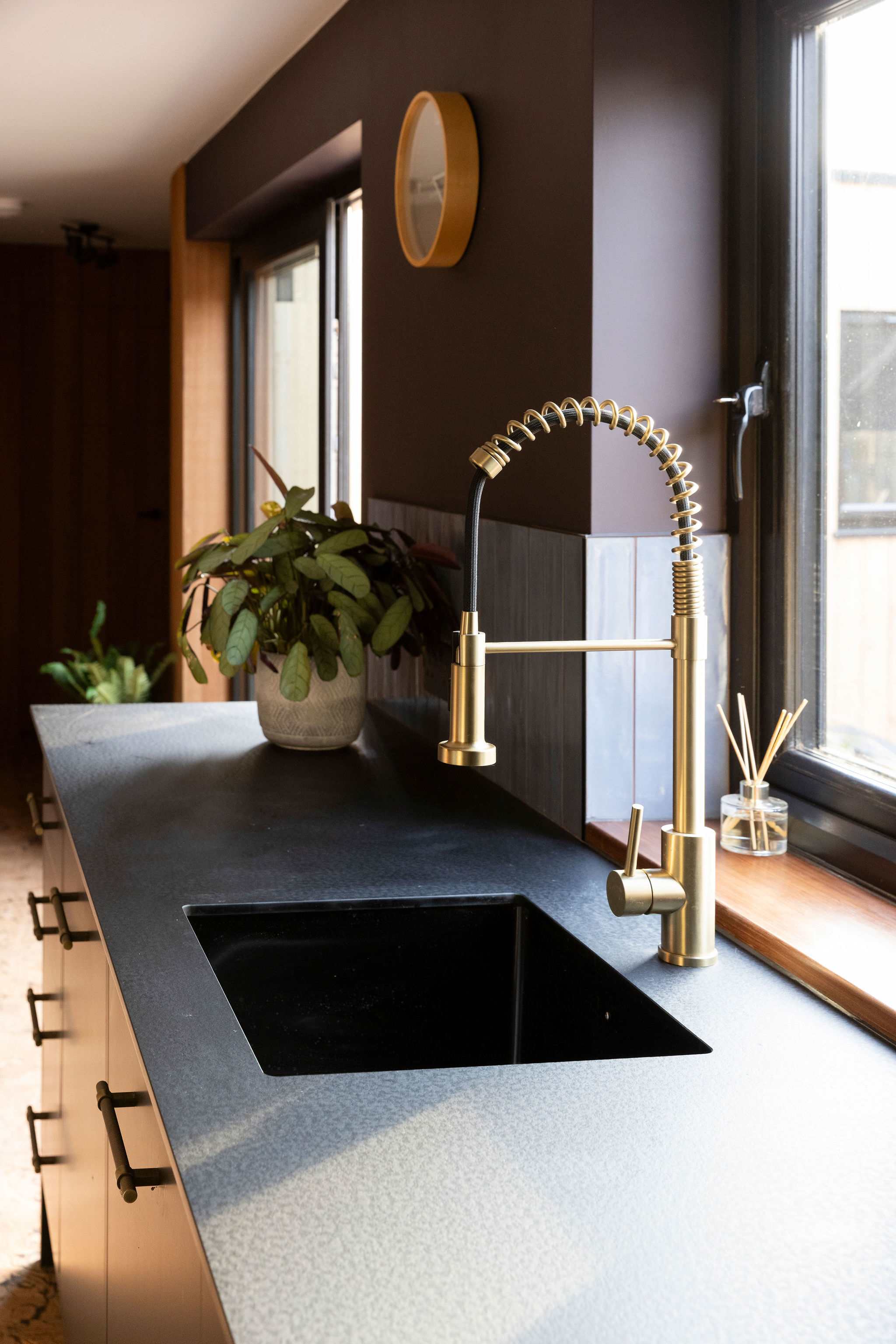 The kitchen sink is fitted with a stunning gold tap.