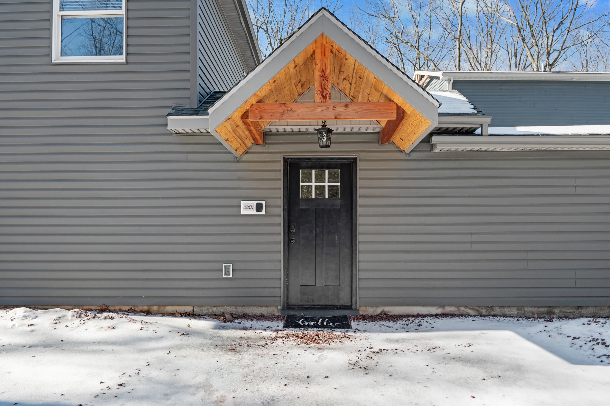 Private Guest Entrance
A dedicated entrance adds privacy and convenience to your stay, tucked beneath a charming cabin-style awning.