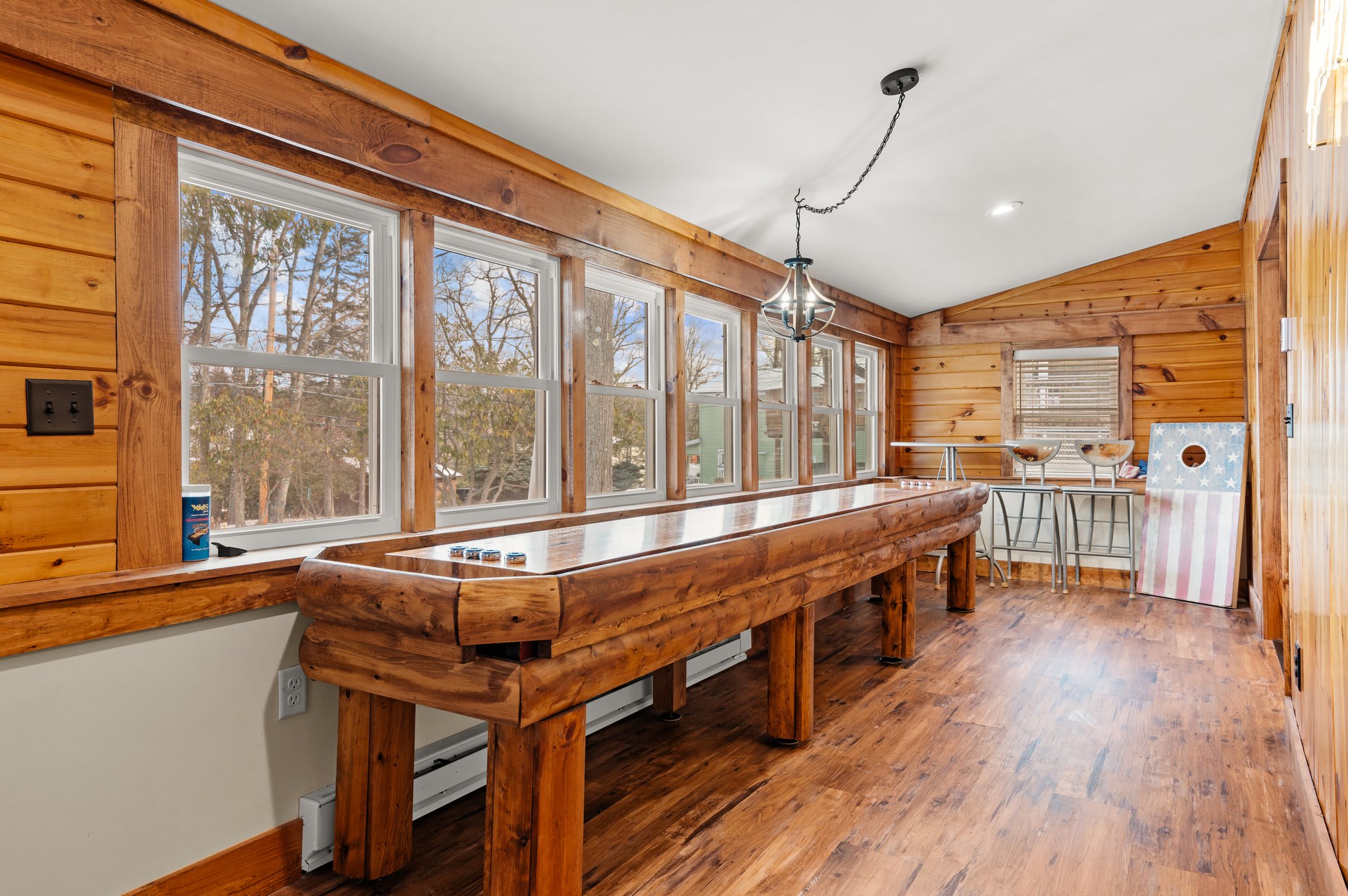 Games in the Sunroom
Plenty of windows, rustic wood, and gaming fun make this spot the hidden gem of the house.