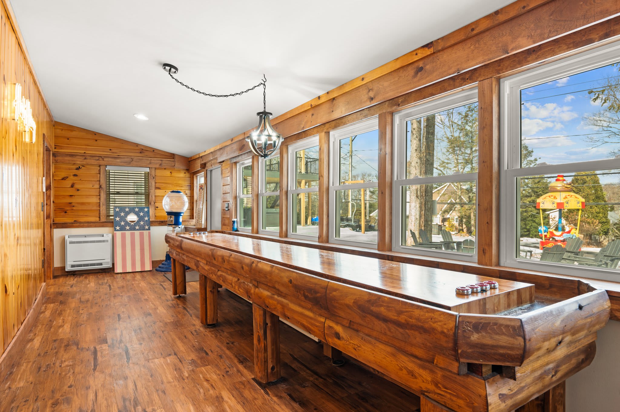 Shuffleboard Challenge Zone
This sunroom-turned-game-room gives you long shuffleboard matches with tons of light and energy.