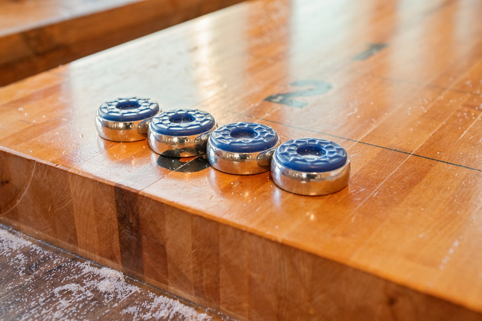 Let the Games Begin
Close-up of the shuffleboard pucks, ready for a friendly match in the game room.
