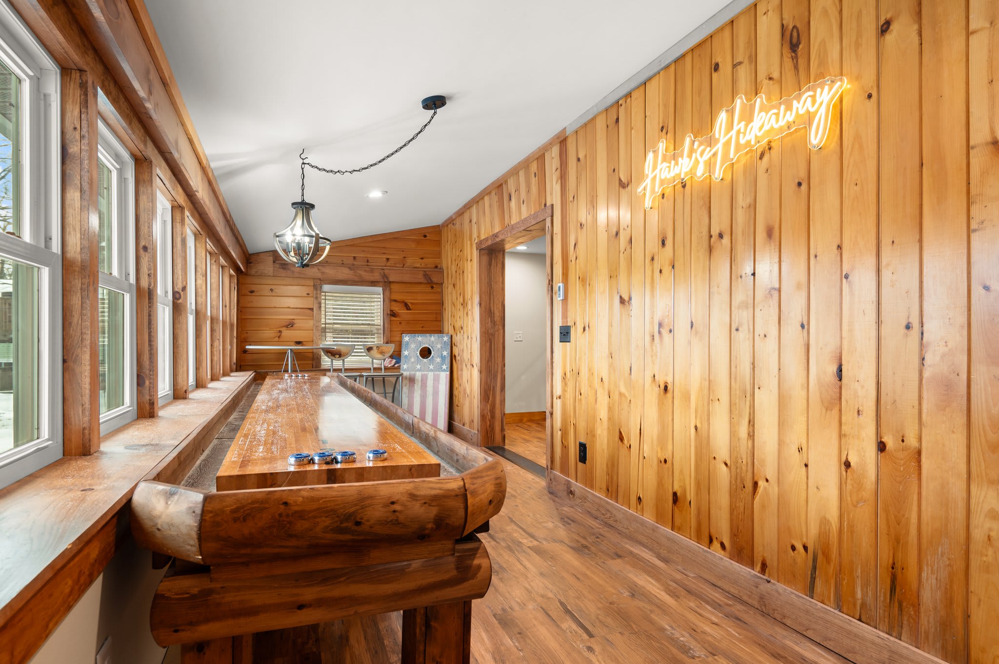 Rustic Bar Vibes
A wall of windows, natural wood accents, and bar seating create a sunny nook for morning coffee or evening drinks.