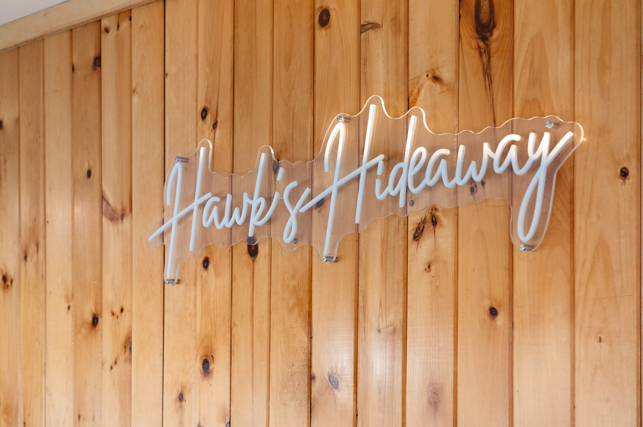 Welcome to Hawk’s Hideaway
A warm wood wall and custom sign set the tone for your rustic mountain retreat.
