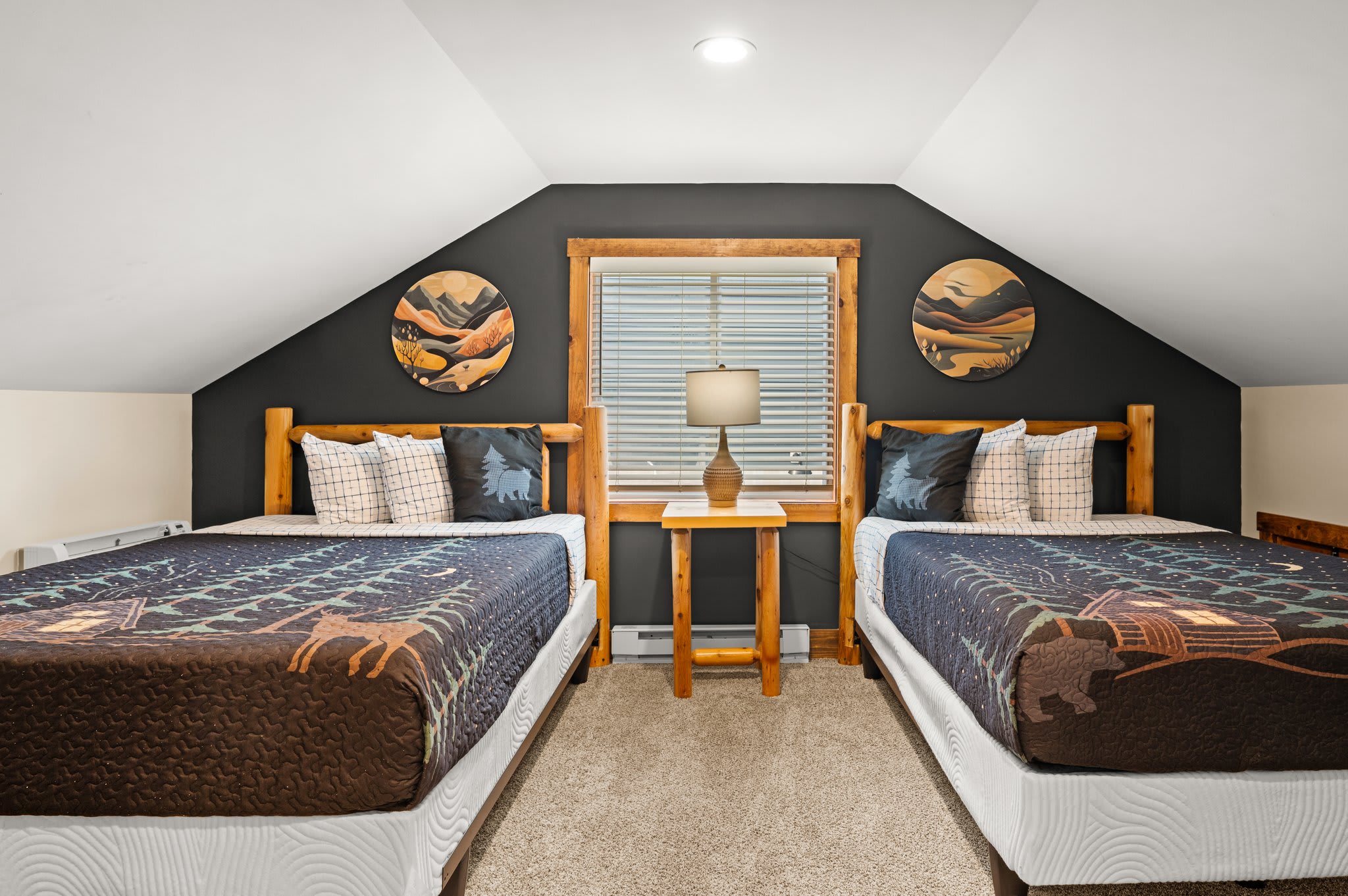 Lodge-Inspired Comfort
2 double beds, lodge-themed decor, and cozy linens make this a standout upstairs space for a great night’s sleep.