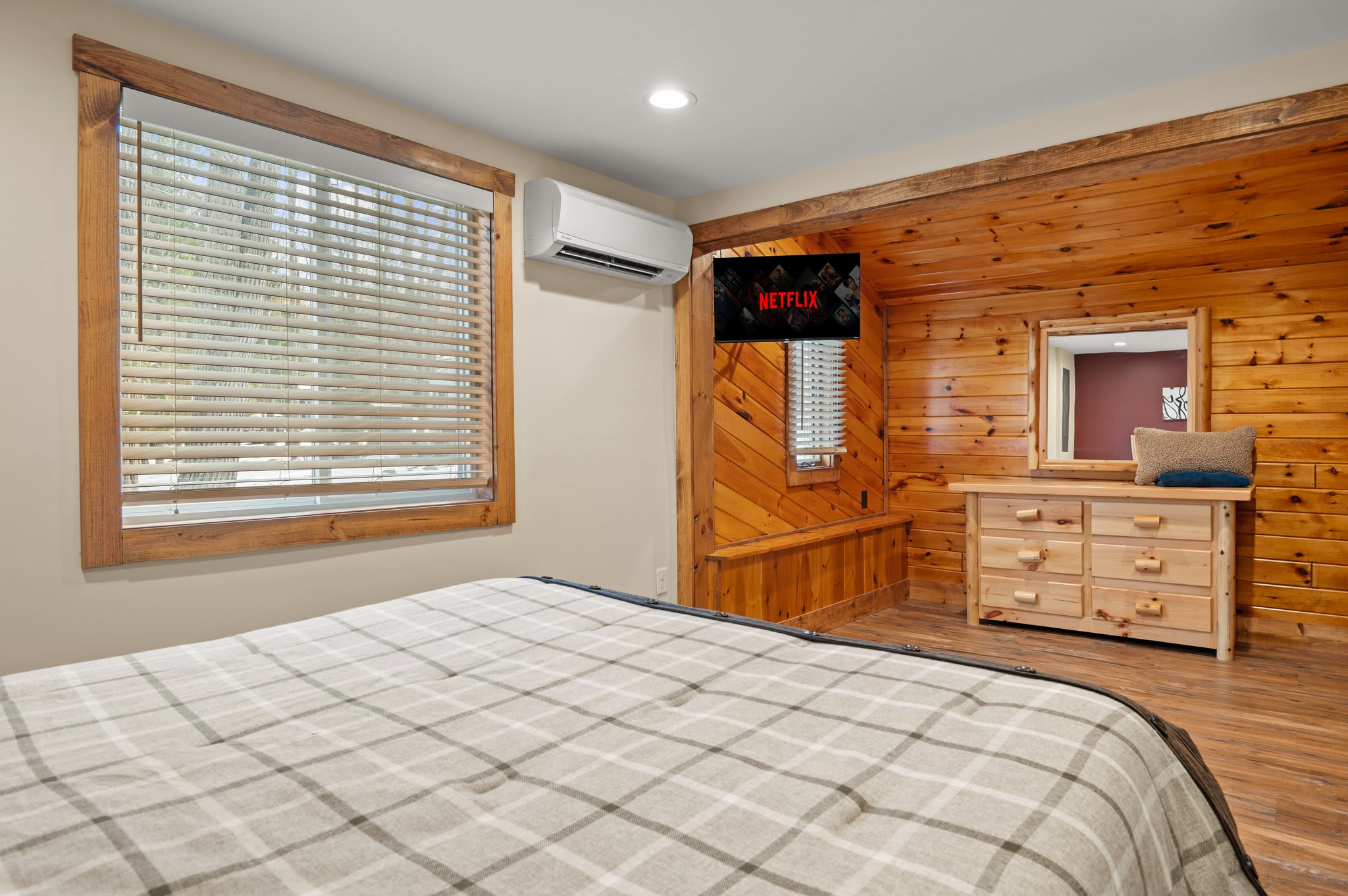 Netflix and Unwind
Rustic pine paneling and a mounted TV make this room ideal for cozy nights and easy mornings.