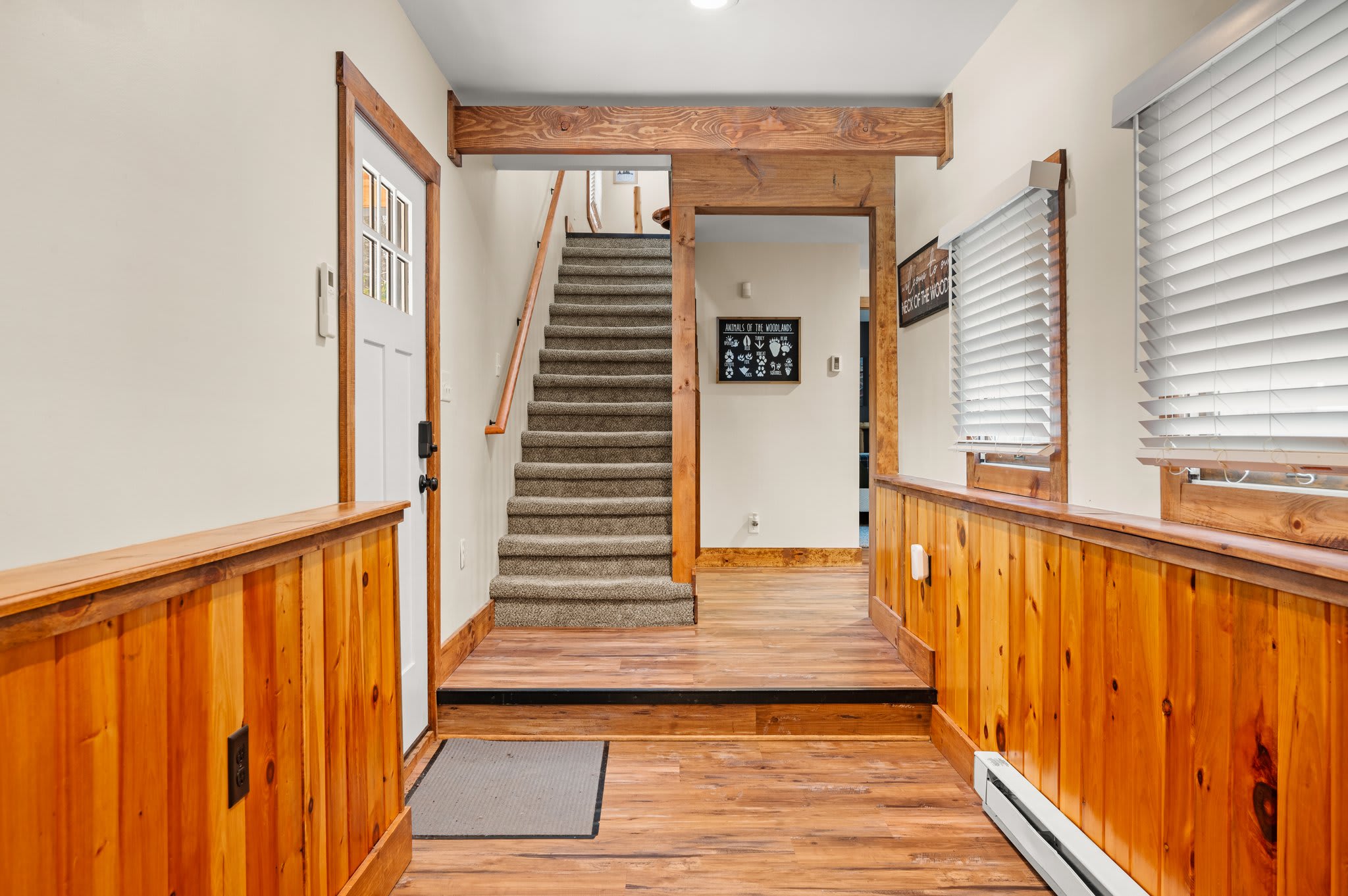 Warm Entryway Welcome
This charming entrance has wood accents, coat hooks, and space to drop your bags and ease into your stay.