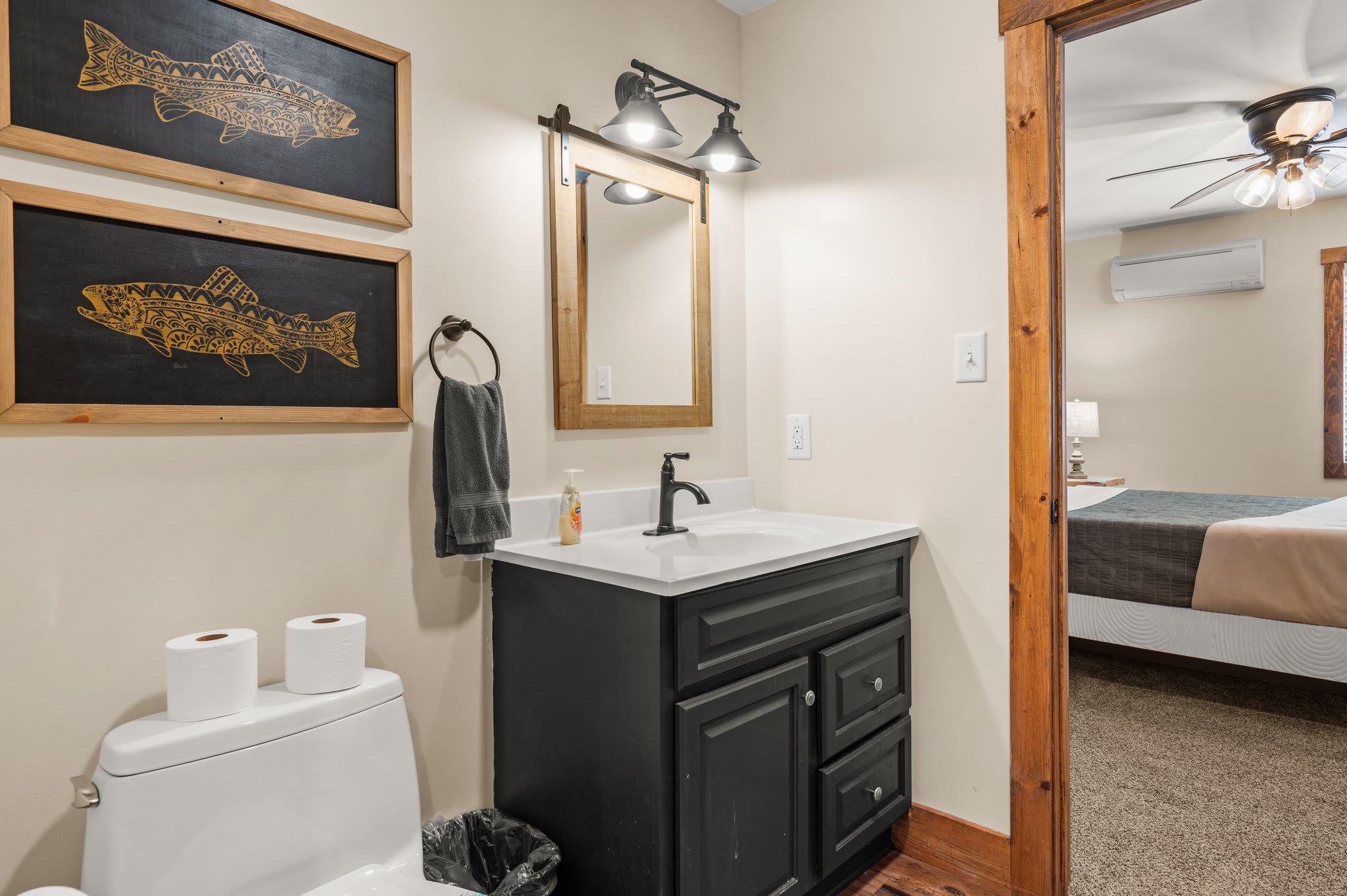 Cozy Bath Retreat
Classic cabin touches meet modern convenience in this tidy bathroom with a stylish vanity and lighting.