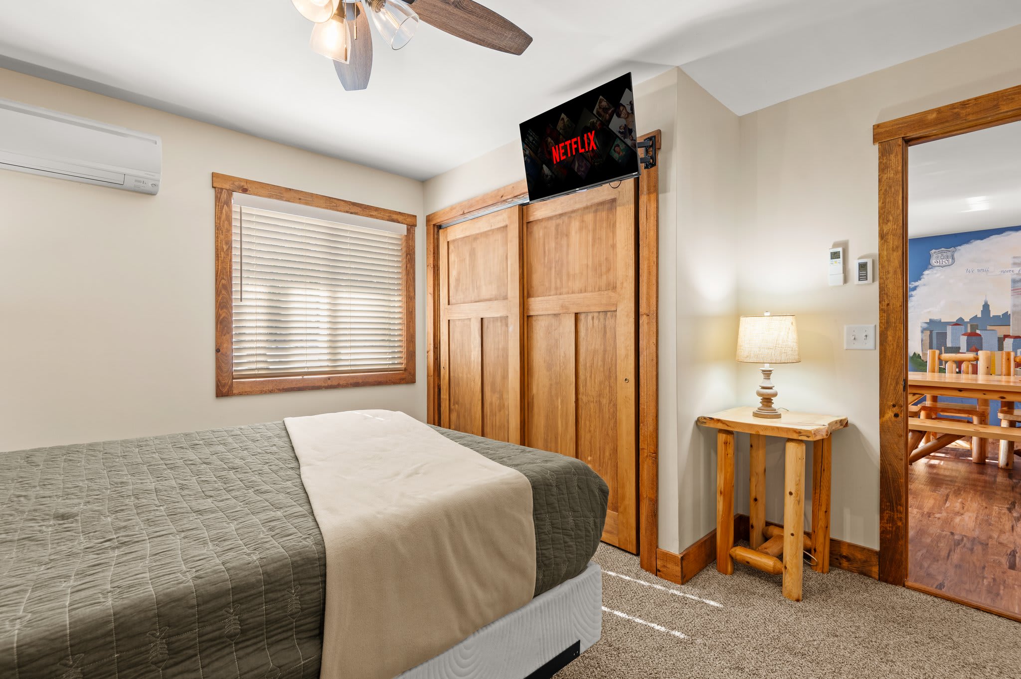 Bedroom with Netflix
A cozy private space featuring soft tones, a ceiling fan, and a wall-mounted TV for easy downtime.