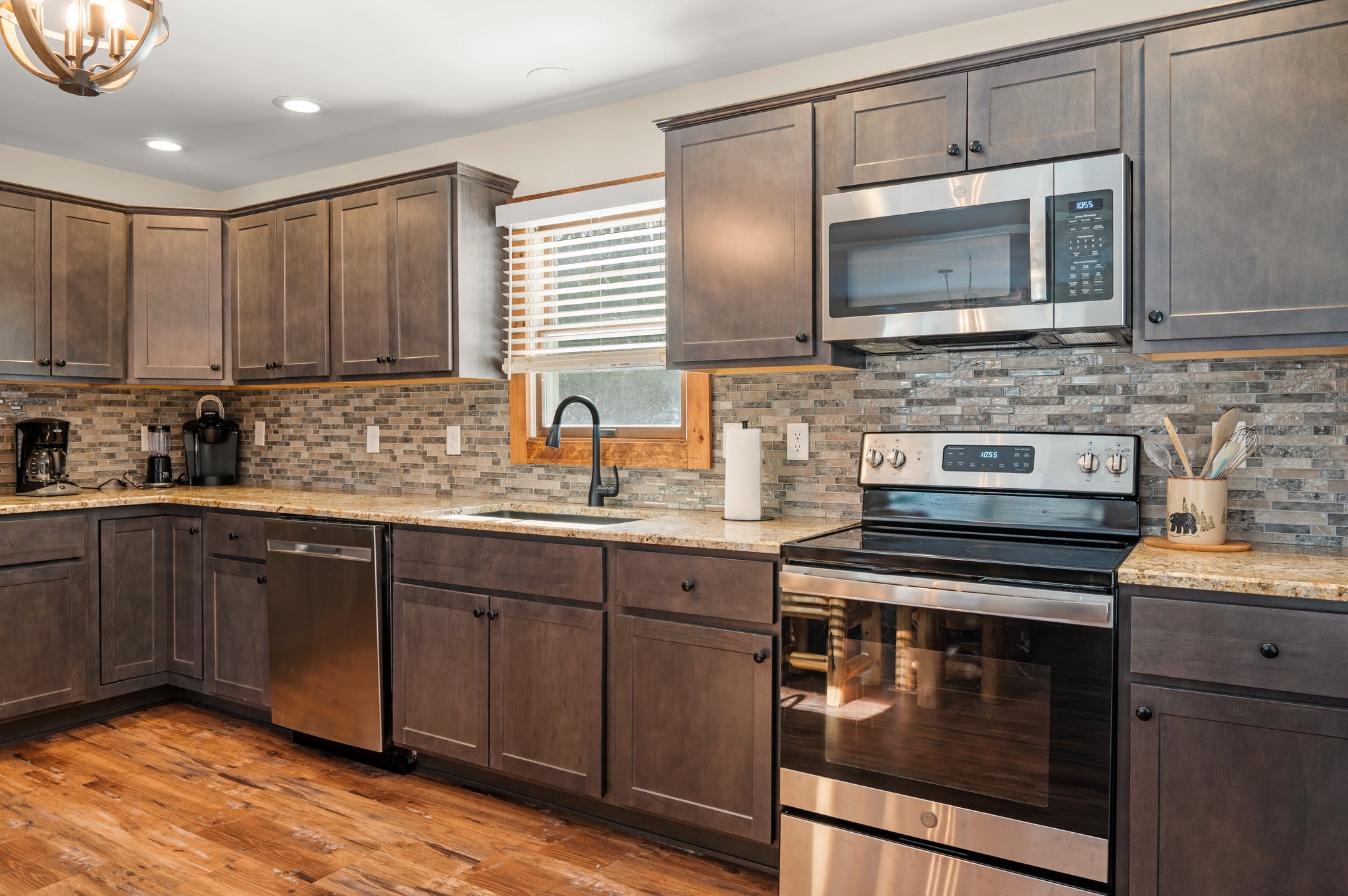 Full Kitchen Setup
Spacious countertops, stainless steel appliances, and rich cabinetry make cooking here a breeze.