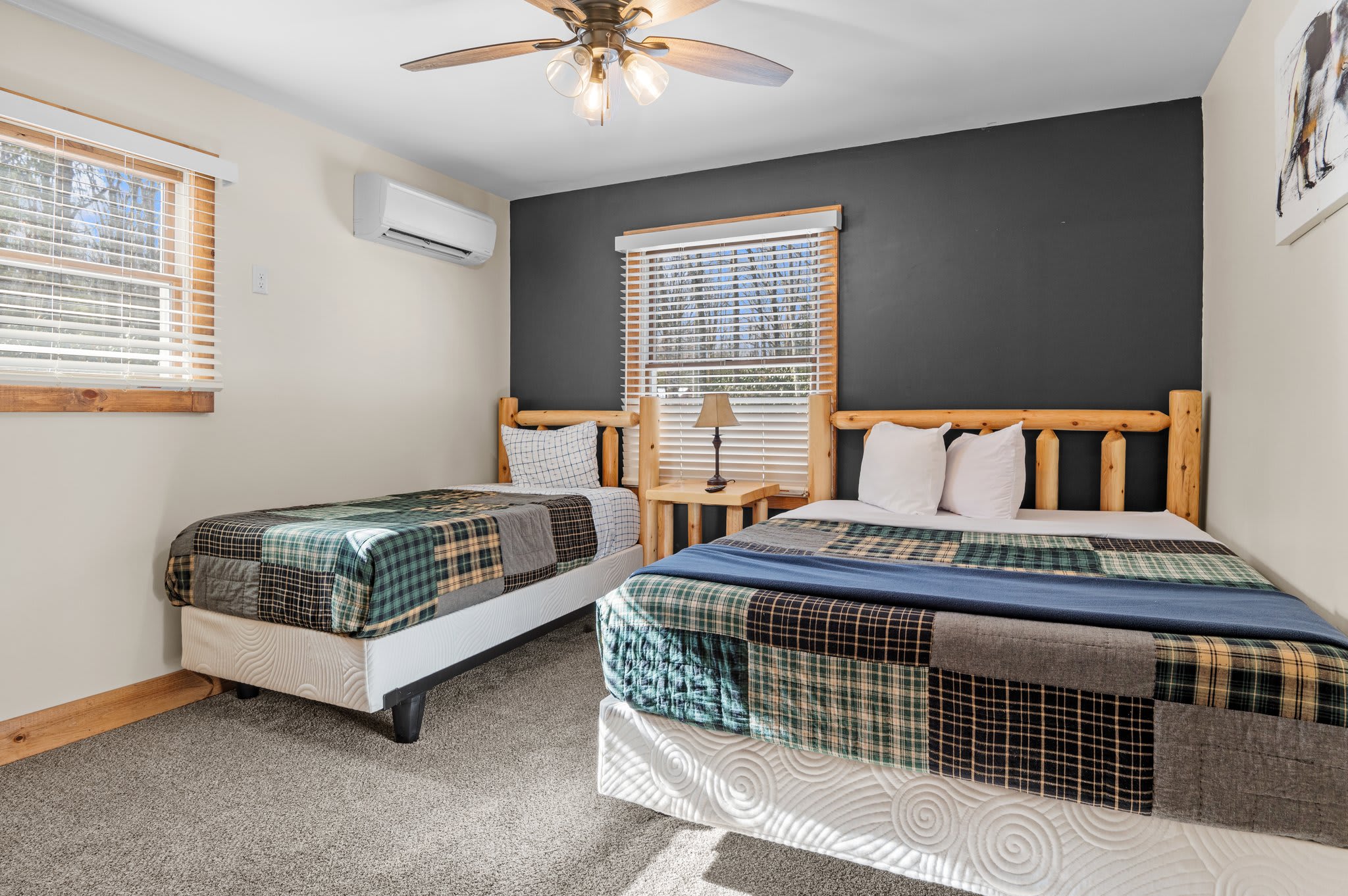 Bedroom with a View
This sunlit bedroom features two beds, a bold accent wall, and plenty of space for friends or family.