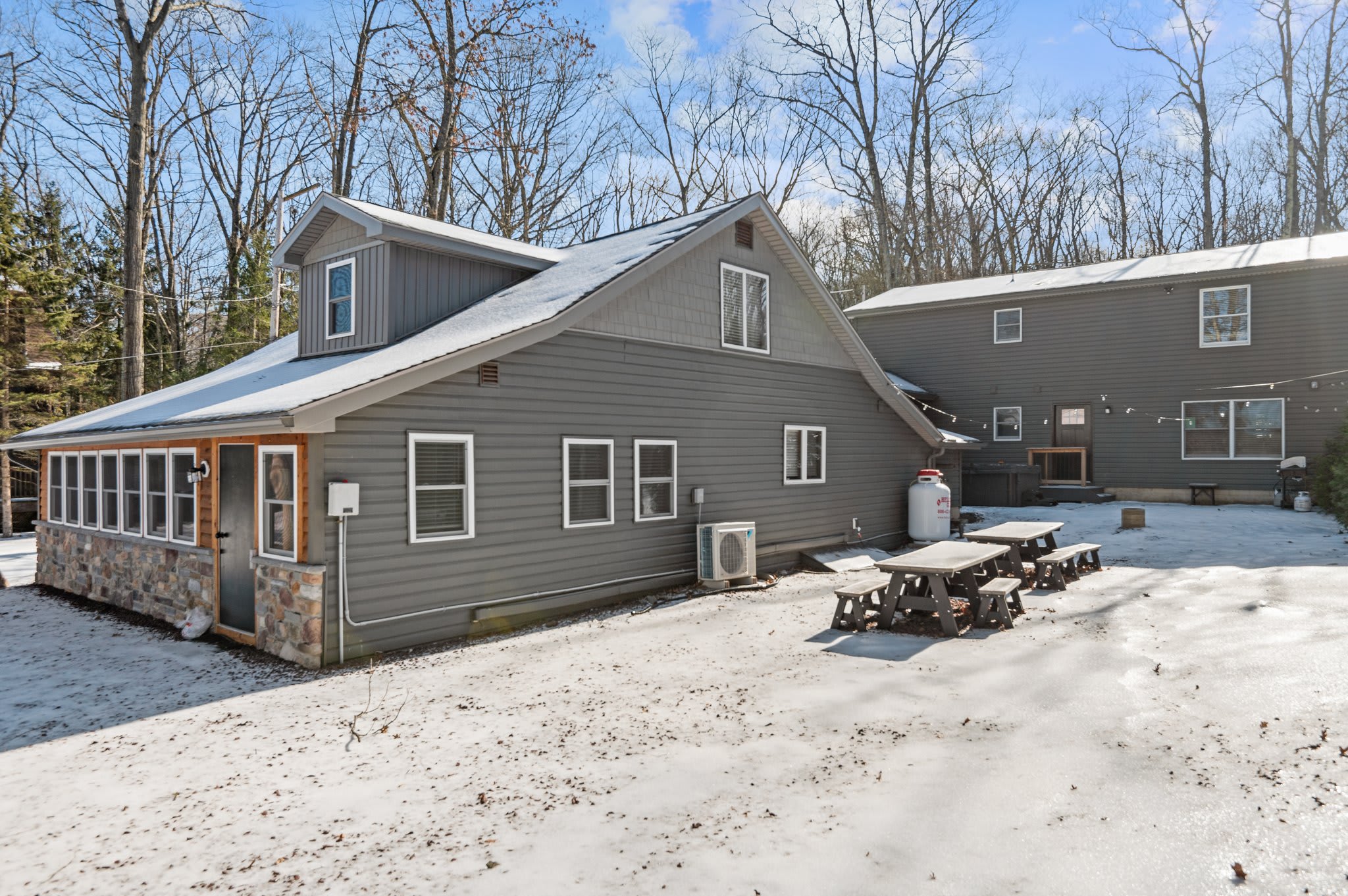 Full Exterior View
A complete look at your private Pocono retreat, featuring a large footprint and multiple outdoor gathering spaces.