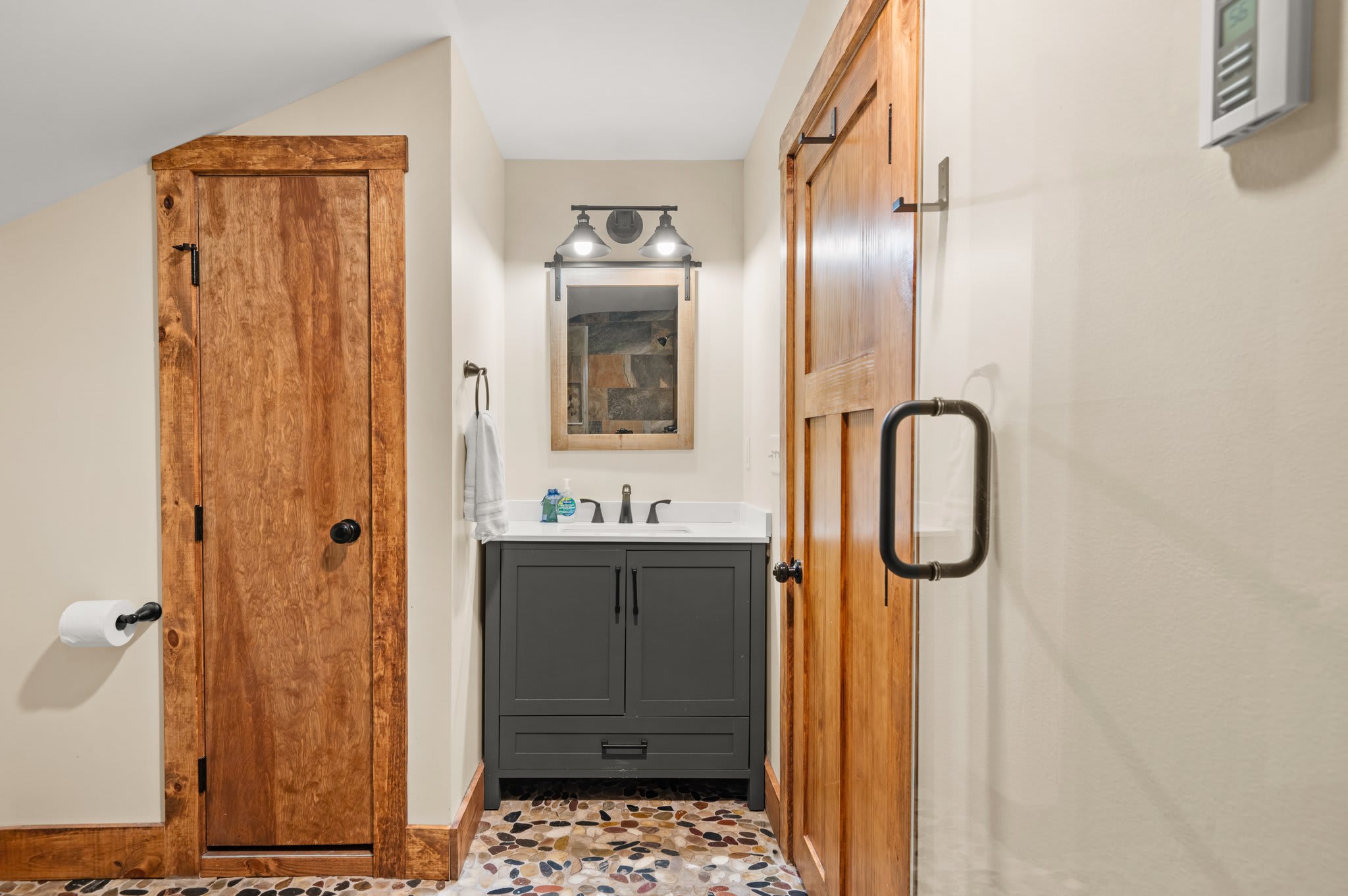 Warm and Stylish Bath
A modern vanity, barn-style door, and wood finishes make this bathroom both functional and inviting.