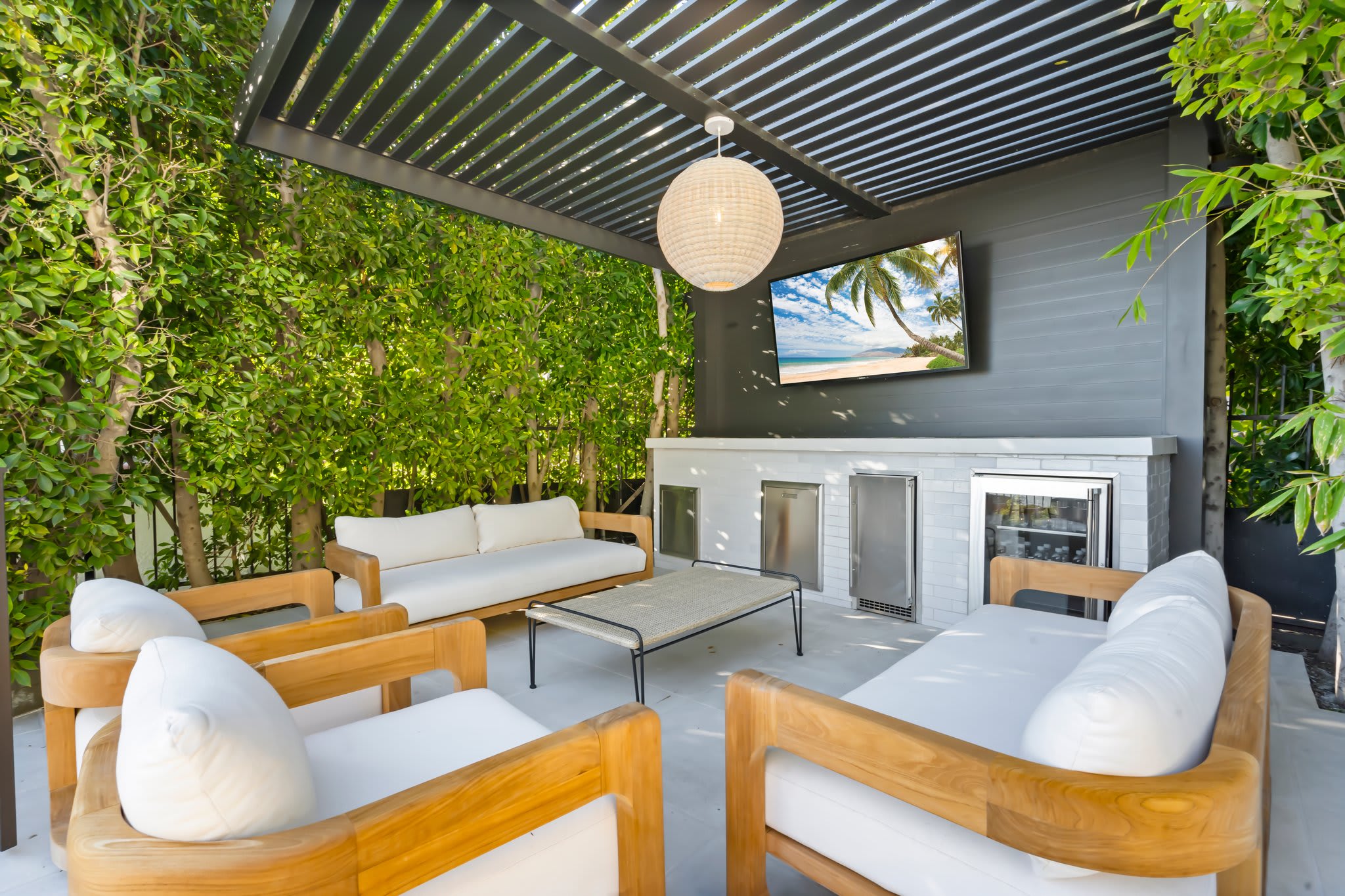 Kick back in a shaded lounge with a Smart TV and built-in bar.