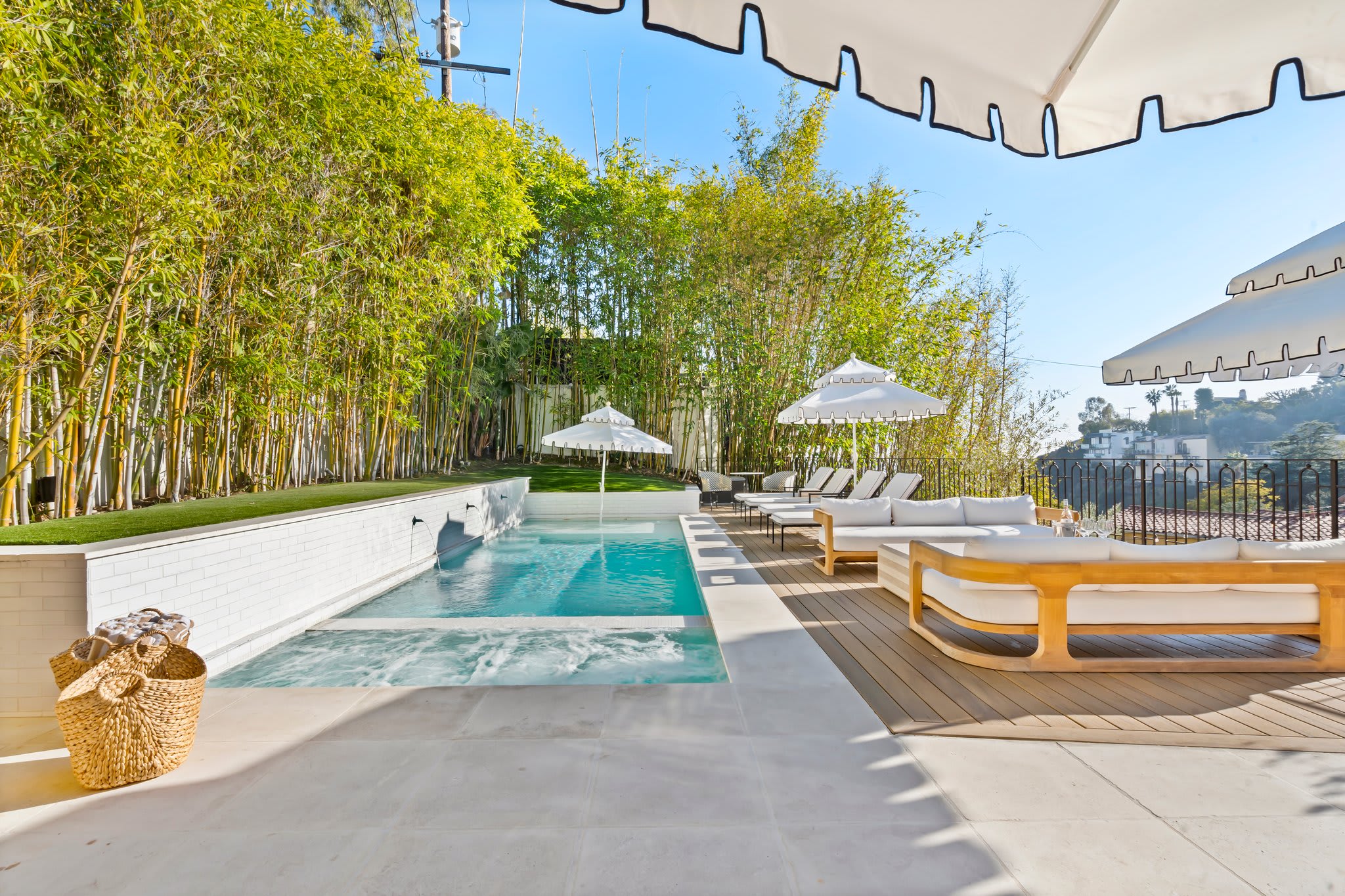 Luxury poolside seating, crisp umbrellas, and lush bamboo for total privacy.