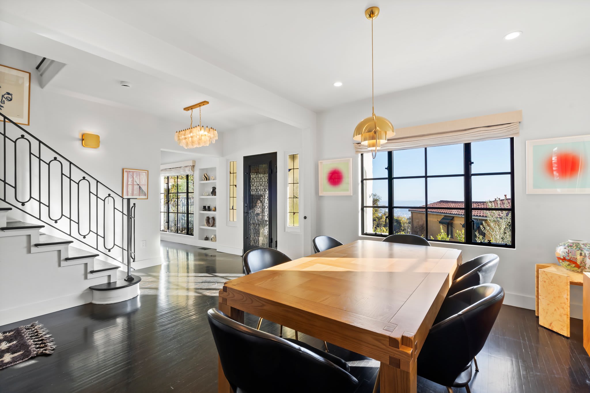 Dine in style with designer pendant lights and expansive outdoor views.