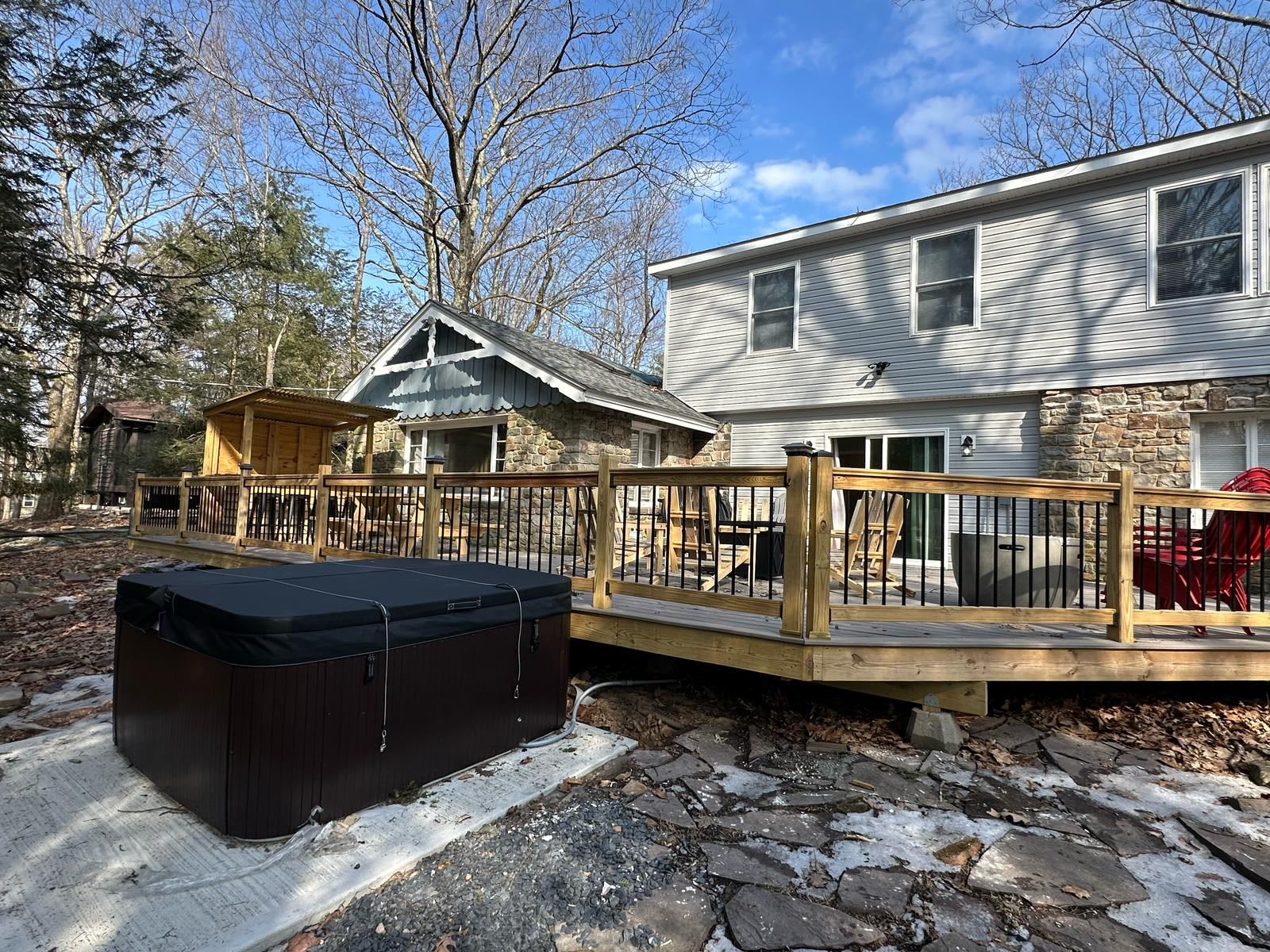 Step outside onto the deck and take in the peaceful surroundings. With ample seating, a hot tub, and direct access to the home, this space is designed for both relaxation and entertainment.