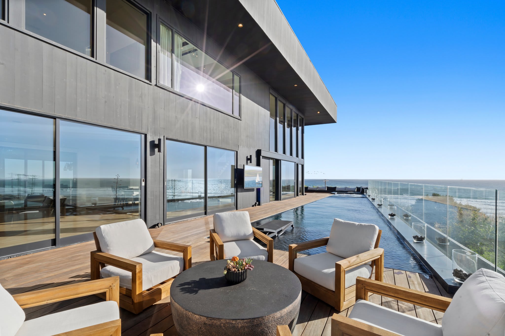 A sleek oceanfront lounge designed for open-air relaxation.