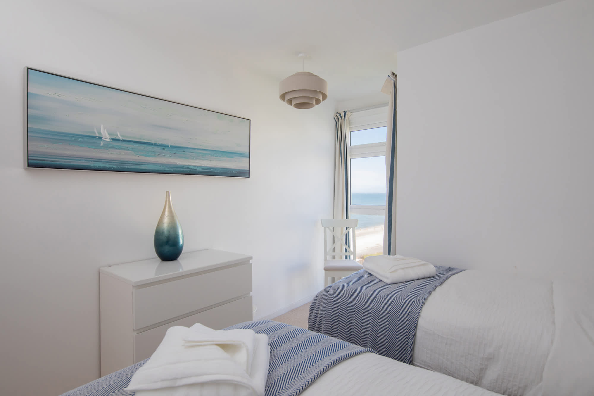 The second bedroom offers two comfortable twin beds and sea views from the floor to ceiling window!