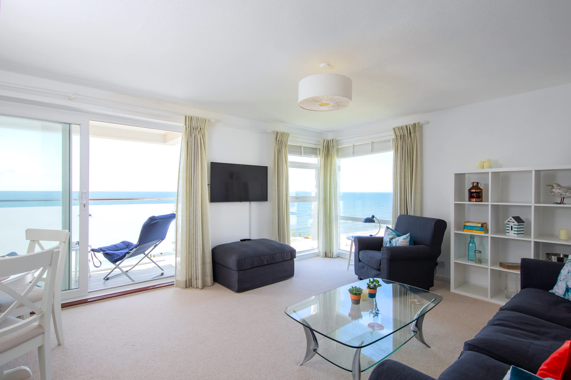 Find your place on the comfy sofa, sofa chair, and ottoman, and enjoy the panoramic sea views!