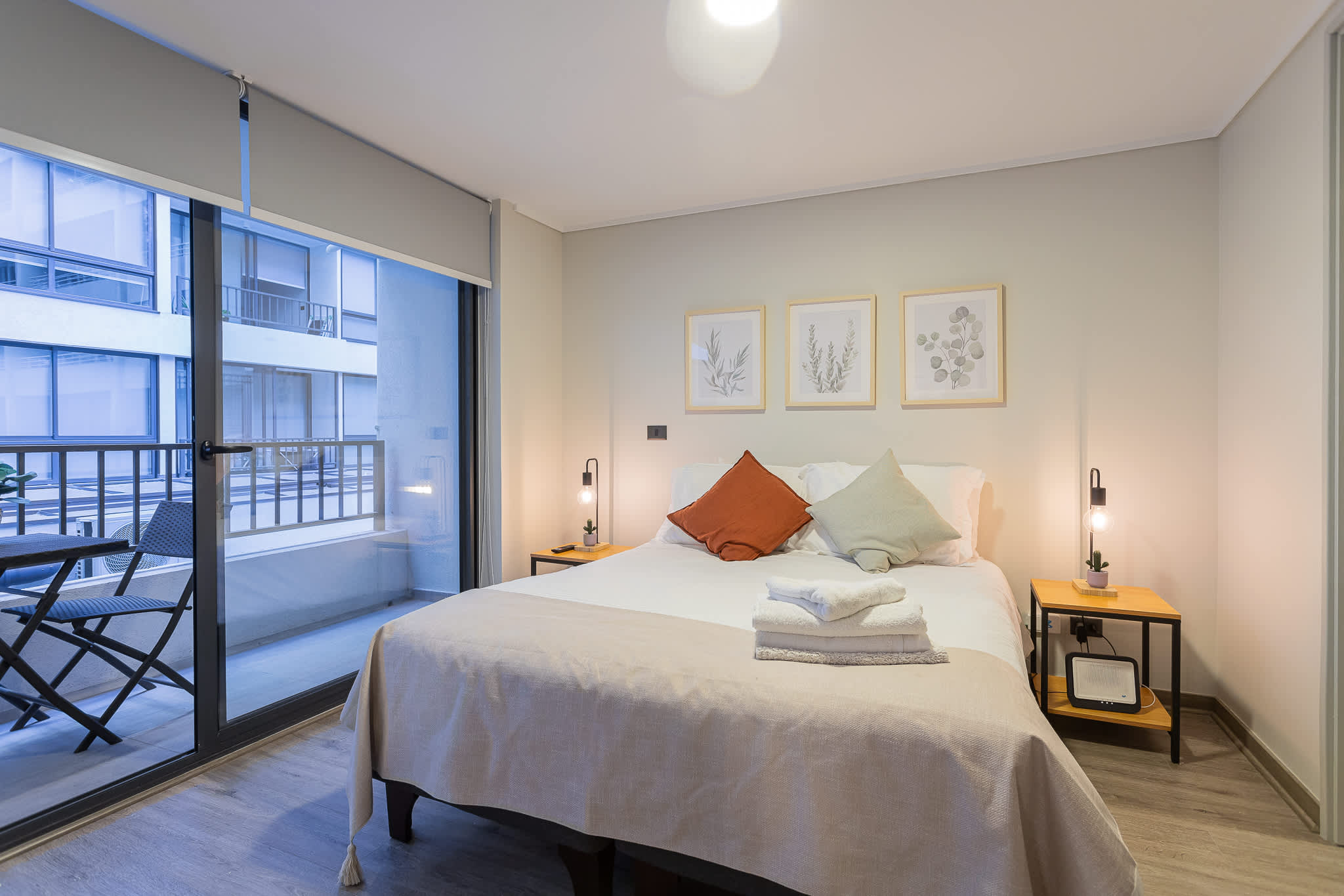 Relax in this cozy bedroom with a private balcony, perfect for enjoying morning coffee or evening relaxation in the heart of the city.