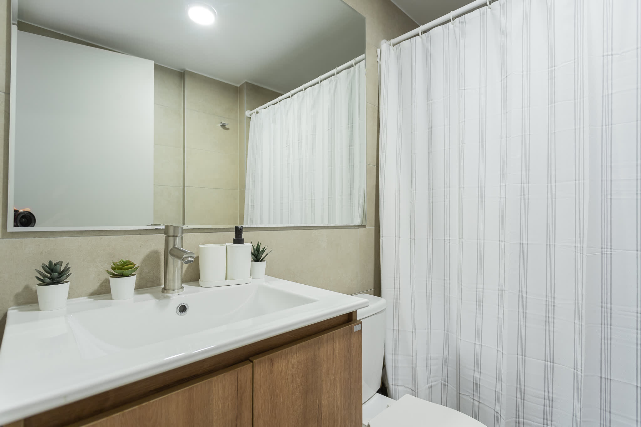 Experience modern comfort in this sleek bathroom, complete with stylish decor and ample lighting.