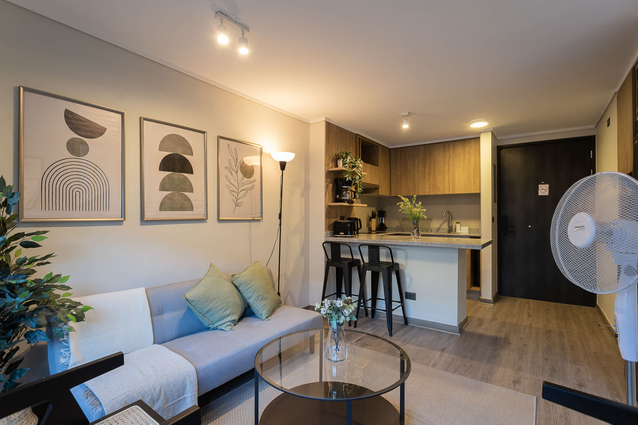 Experience comfort in this stylish studio with a cozy living area and modern kitchen, perfect for a relaxing stay.