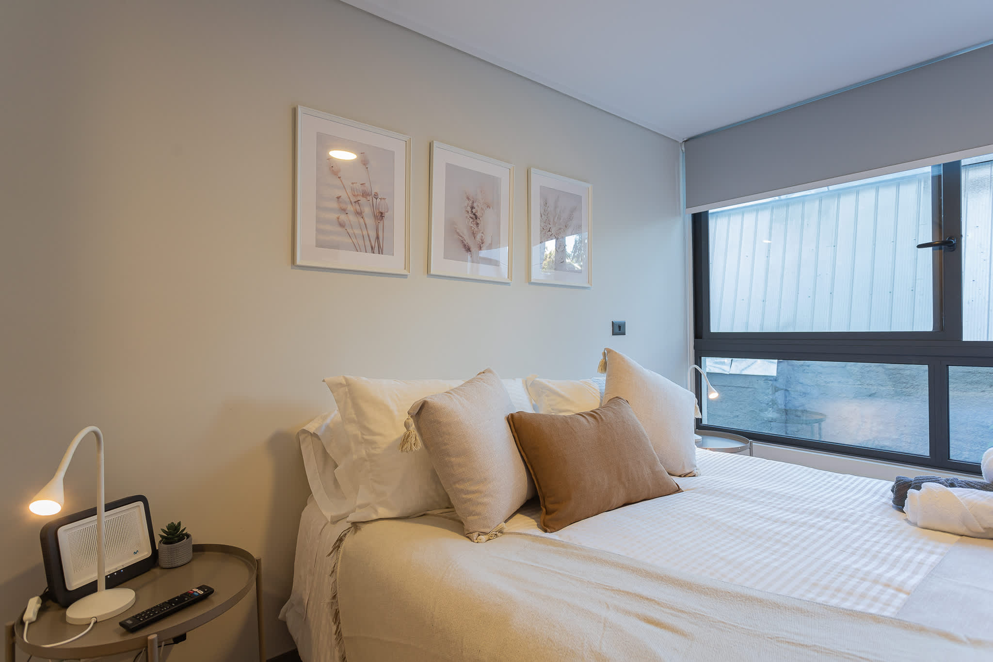 Relax in this serene bedroom with natural light and stylish decor, perfect for a restful stay in the heart of the city.