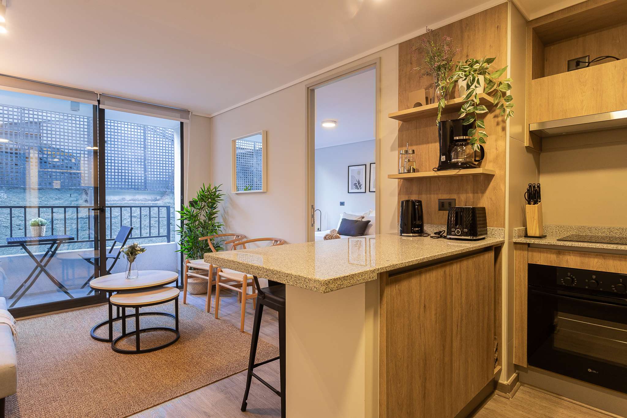Enjoy a cozy retreat with a modern kitchenette and private balcony in this stylish studio apartment.