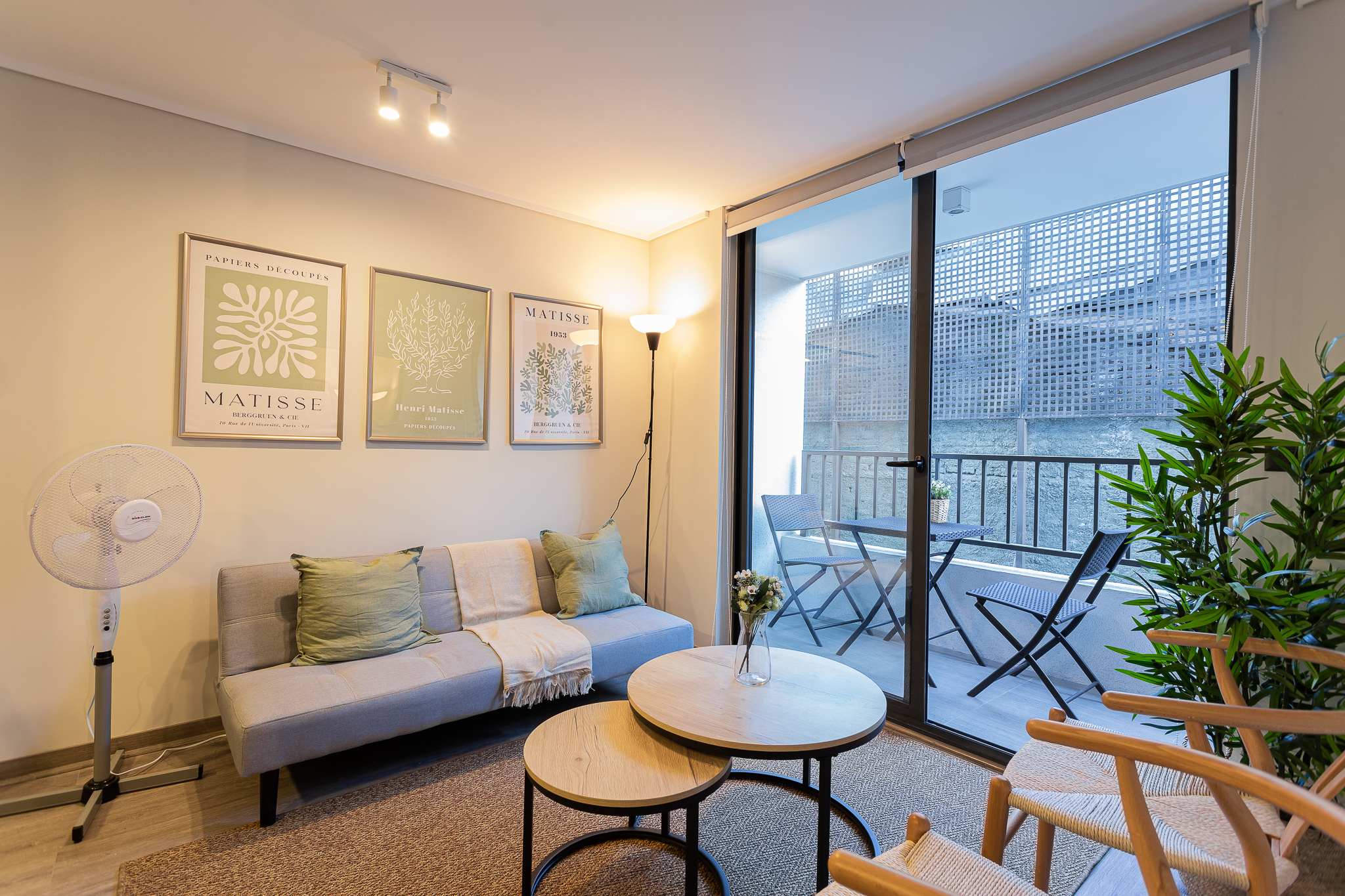 Relax in this cozy living room with stylish decor and a charming balcony view, perfect for unwinding after a day exploring the city.