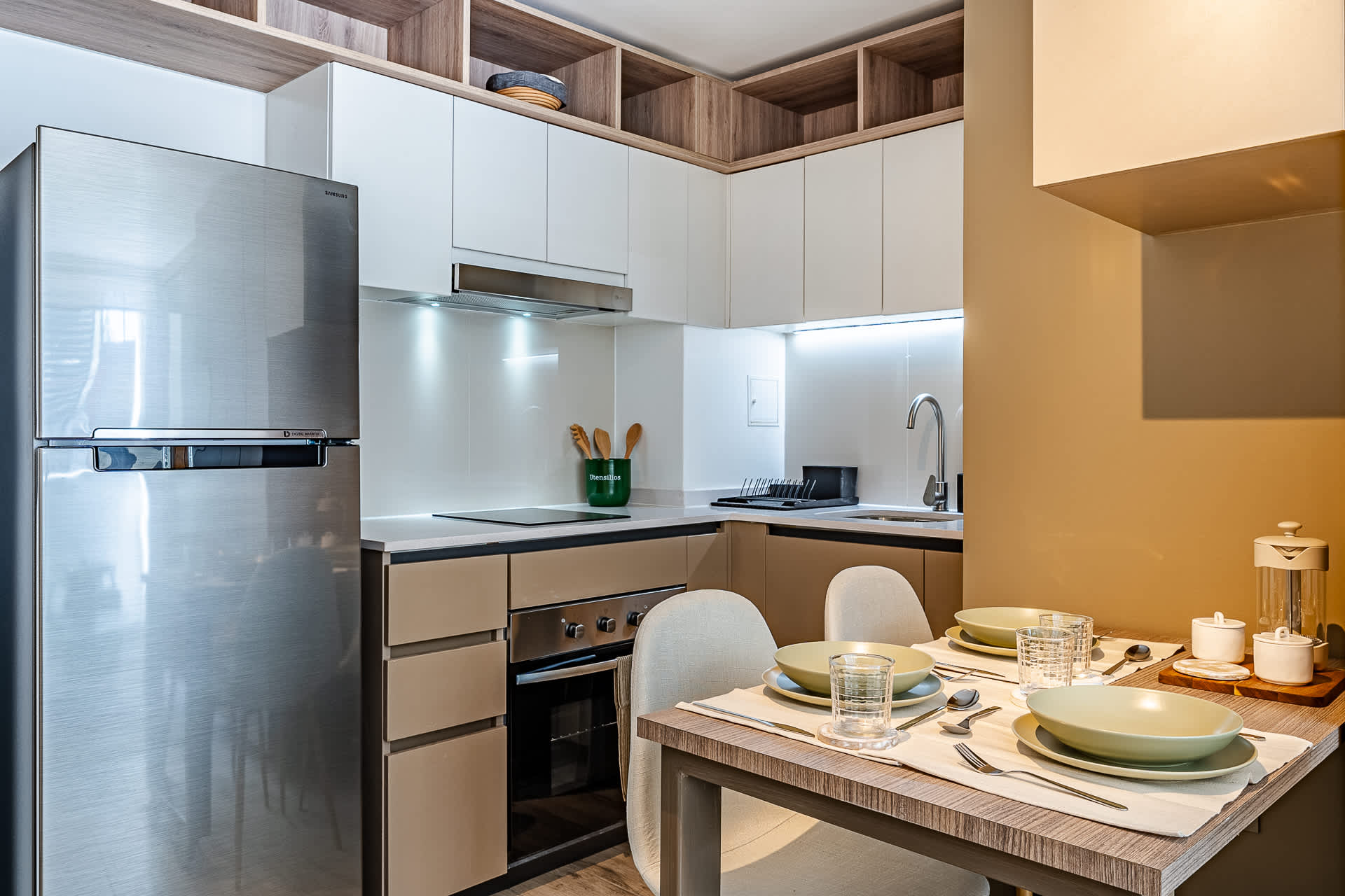 Experience culinary bliss in this modern kitchen, featuring sleek appliances and a cozy dining area perfect for memorable meals.