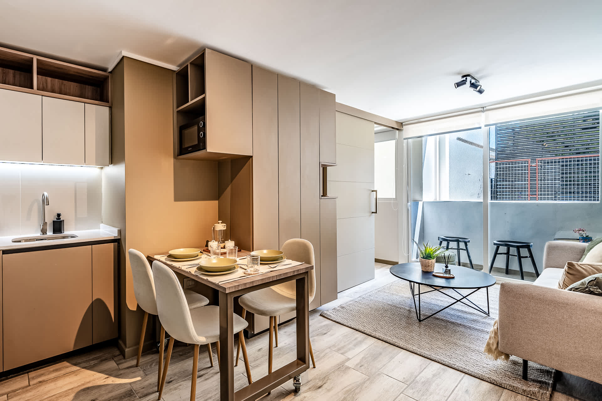 Experience modern living in this stylish space, featuring a cozy dining area and bright, airy ambiance perfect for relaxation.