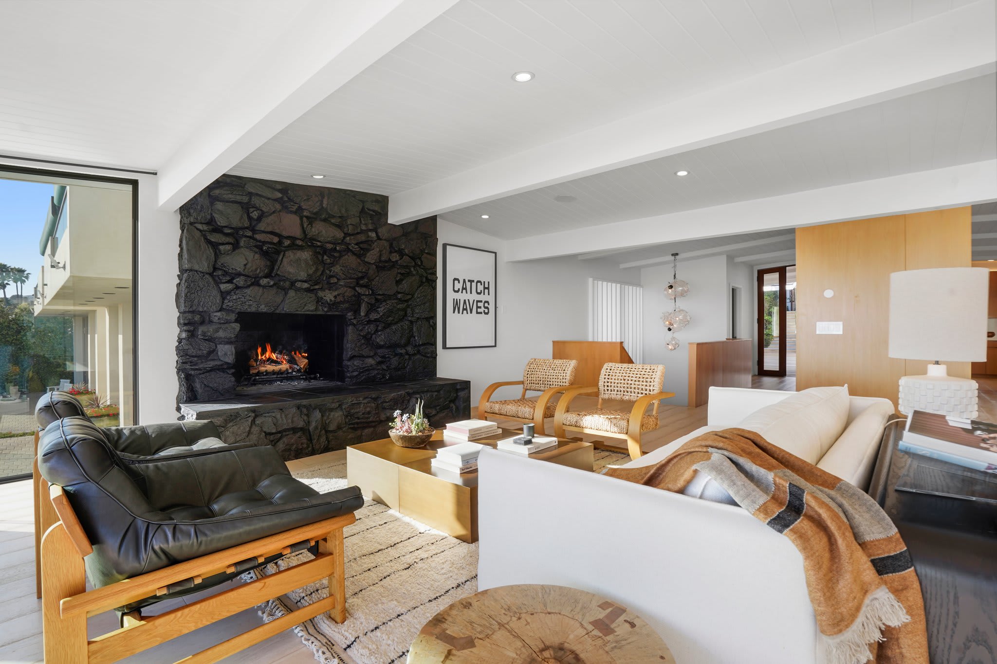 Stretch out on plush seating, framed by coastal textures and modern design.