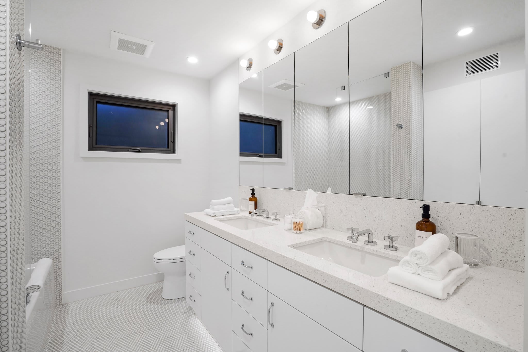 A refined vanity with designer finishes and plush towels.