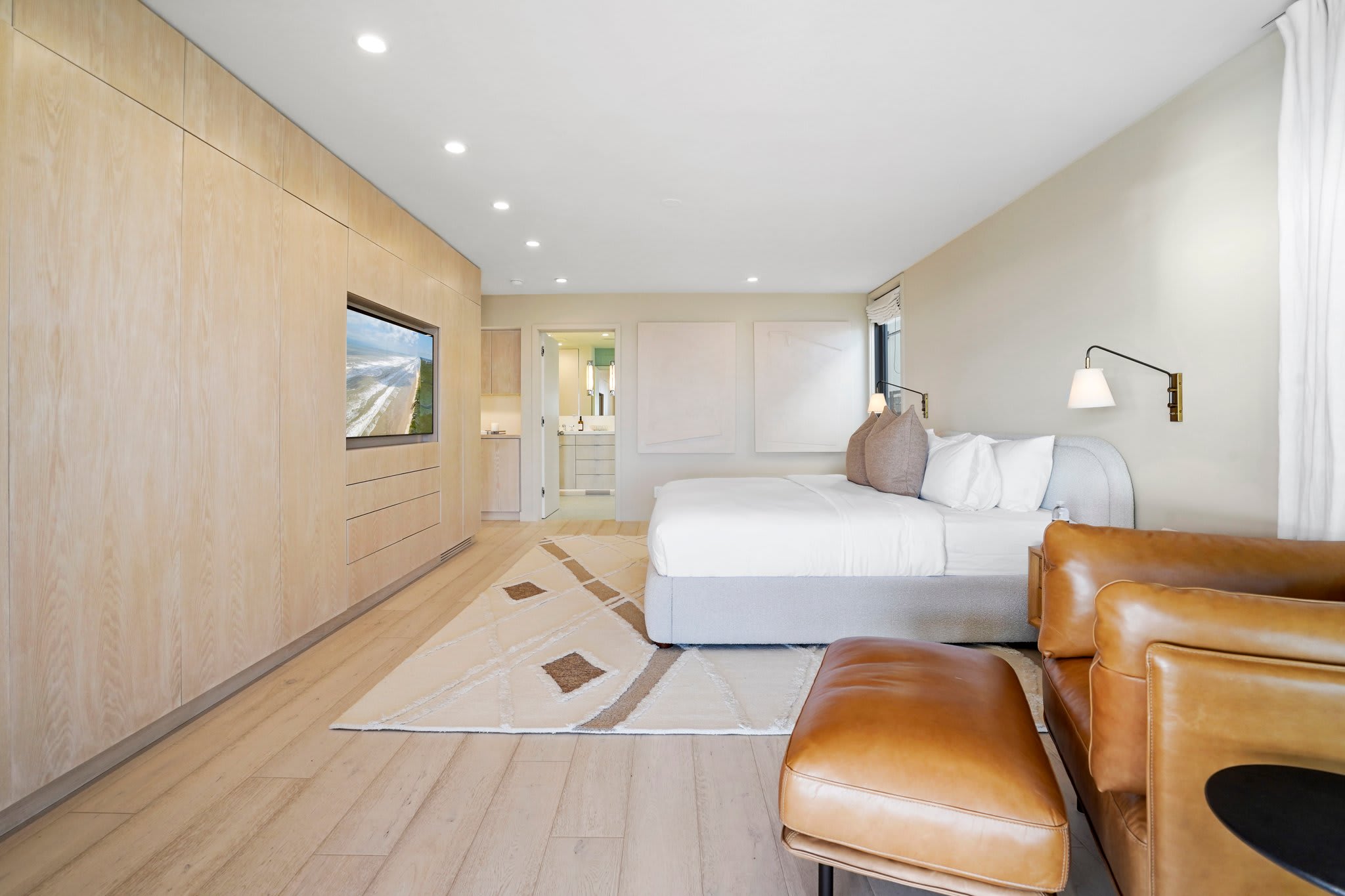 Every detail is curated—from the tailored built-ins to the inviting leather lounge chair.