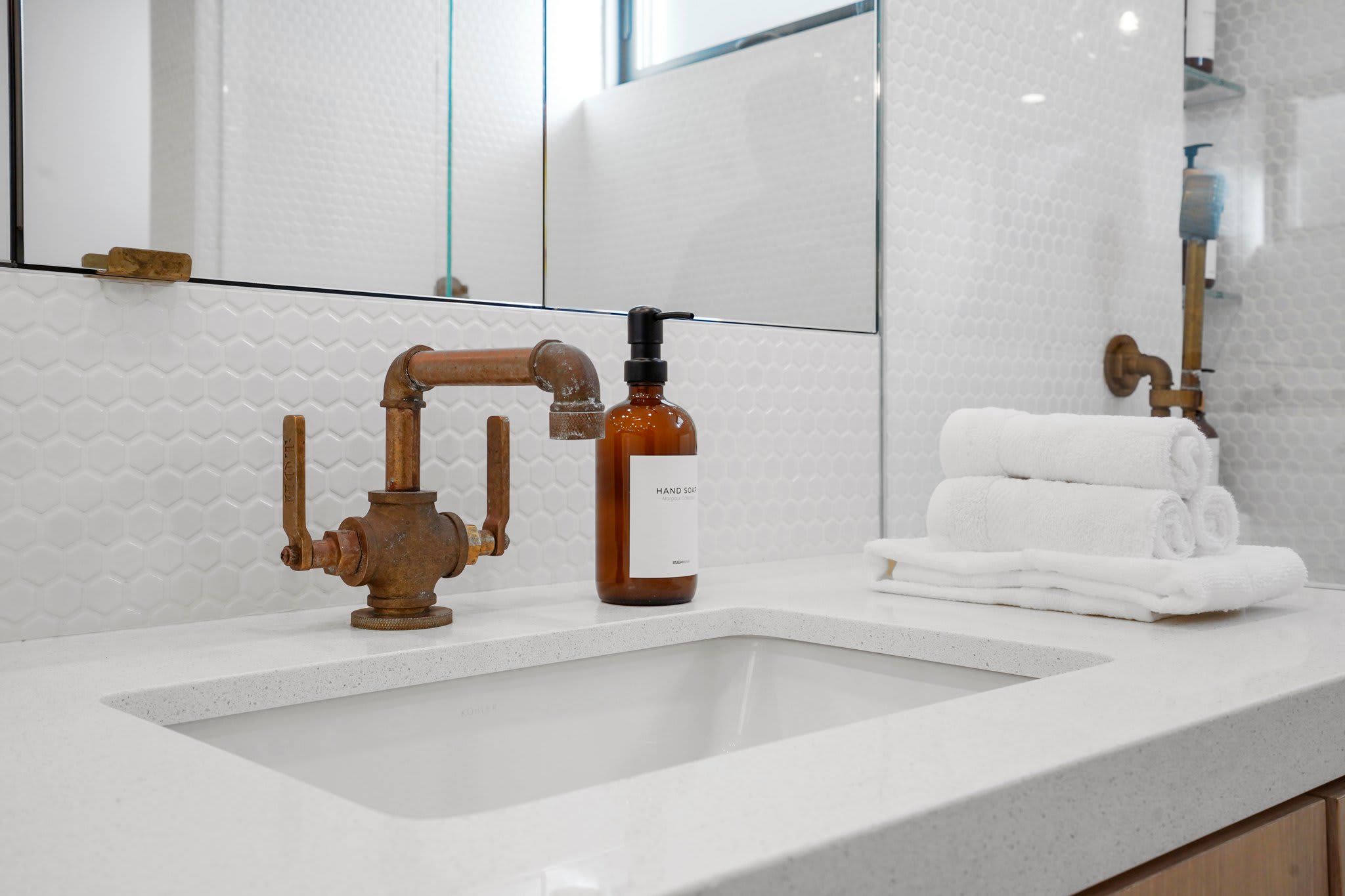 Modern design, premium bath essentials, and warm brass accents.
